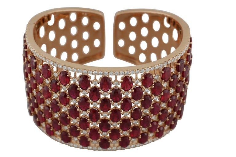 This wide cuff style bracelet is made of 18kt rose gold, is set with 88 oval cut natural Burmese rubies weighing over 49ct and 4.29ct of white diamonds.