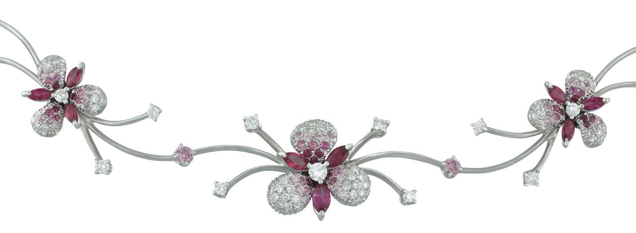 This gorgeous Stefan Hafner signed choker style necklace is made in 18kt white gold and features natural pink sapphires and pave diamonds in orchid stations.