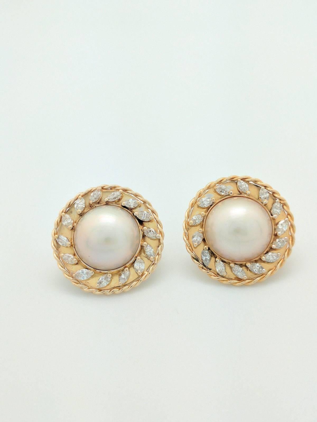 You are viewing a stunning pair of vintage 15.5 mm Mabe Pearl & Marquise Diamond Earrings.

These earrings were handmade and crafted from 14 karat yellow gold and weigh 18.6 grams. Each earring features (1) 15.5 mm Mabe Pearl and (14) .10 to .12