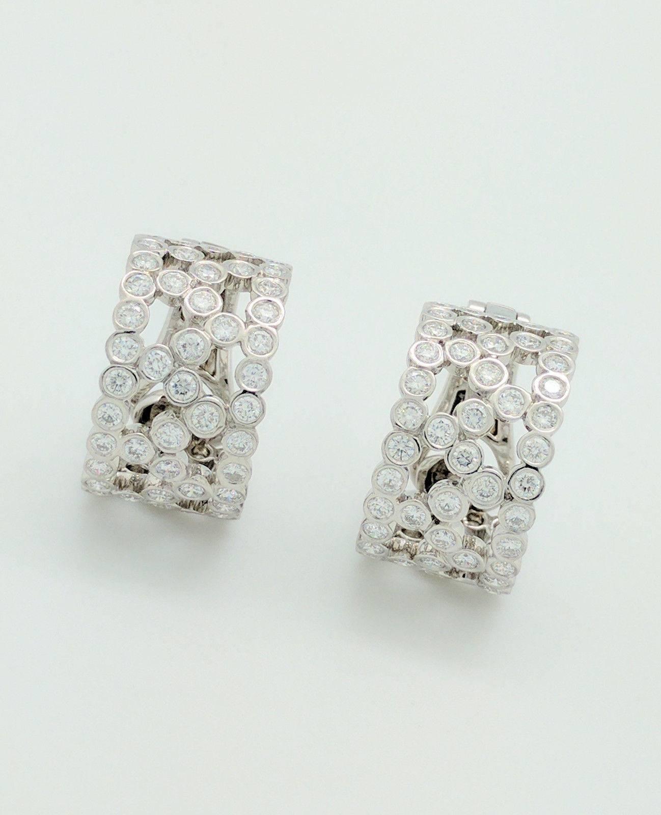  You are viewing a pair of authentic retired Tiffany & Co. 3.54ctw diamond half hoop earrings from the Bubbles Collection.
The earrings are crafted from platinum and weigh 17.8 grams. Each earring features (59) .03ct natural round bezel set