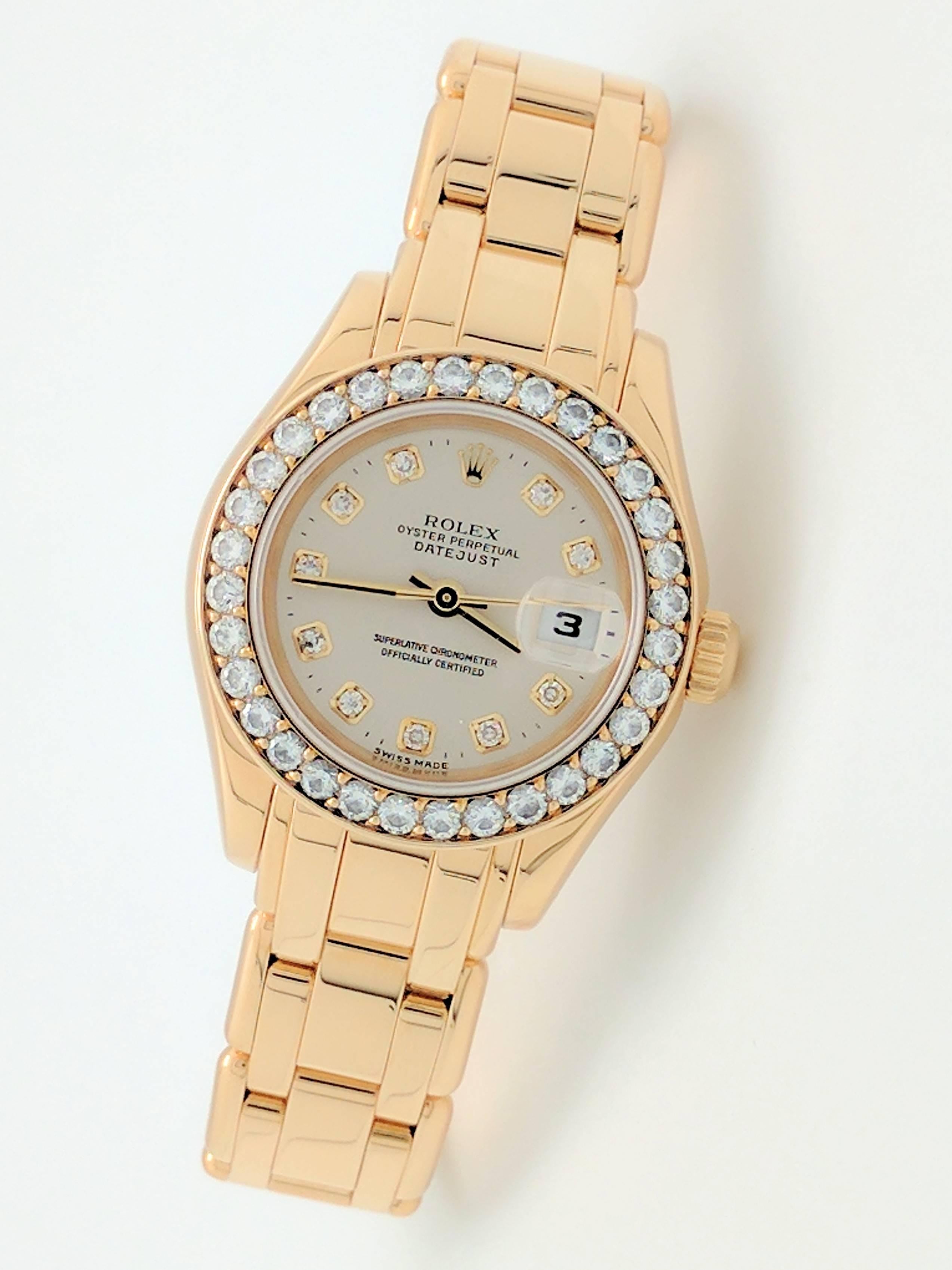 You are viewing an Authentic and all original Rolex 18KYG Pearlmaster ladies Watch. Model: 69298  Serial: "W" (1995).

This watch is automatic with a date and features a beautiful original Rolex silver dial with diamond markers and gold