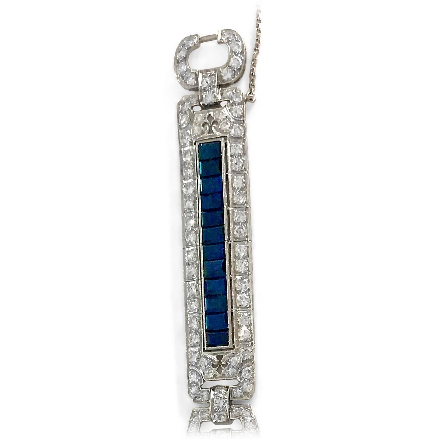 This is Art Deco at its very finest ... an original wide-band 1930s bracelet featuring over 8 carats of diamonds and 4.80 carats of genuine emerald-cut sapphires (not faux sapphires, as was commonly found during the period.) Three larger center