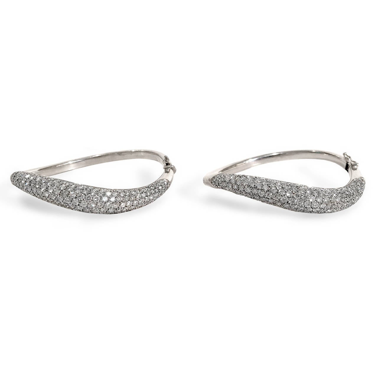 Contemporary Italian-made cuff bracelet duet in 18k white gold.  Each bracelet features approximately 5.88 carats of round-cut diamonds (G color, All VS range for a stunning total of 11.76 carats.  Snuggle them up next to each other or wear one on