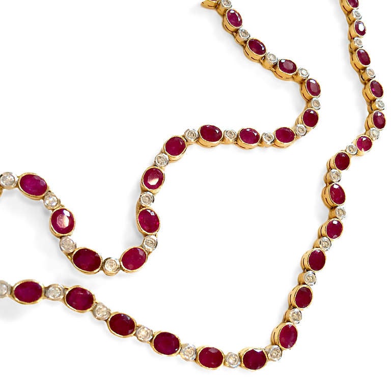18k yellow gold. Approximately 21ct (total weight) gorgeous oval faceted Burma rubies interspersed with 2.8ct round, brilliant cut diamonds. Handmade mounting. 19” overall length. Matching earrings available.