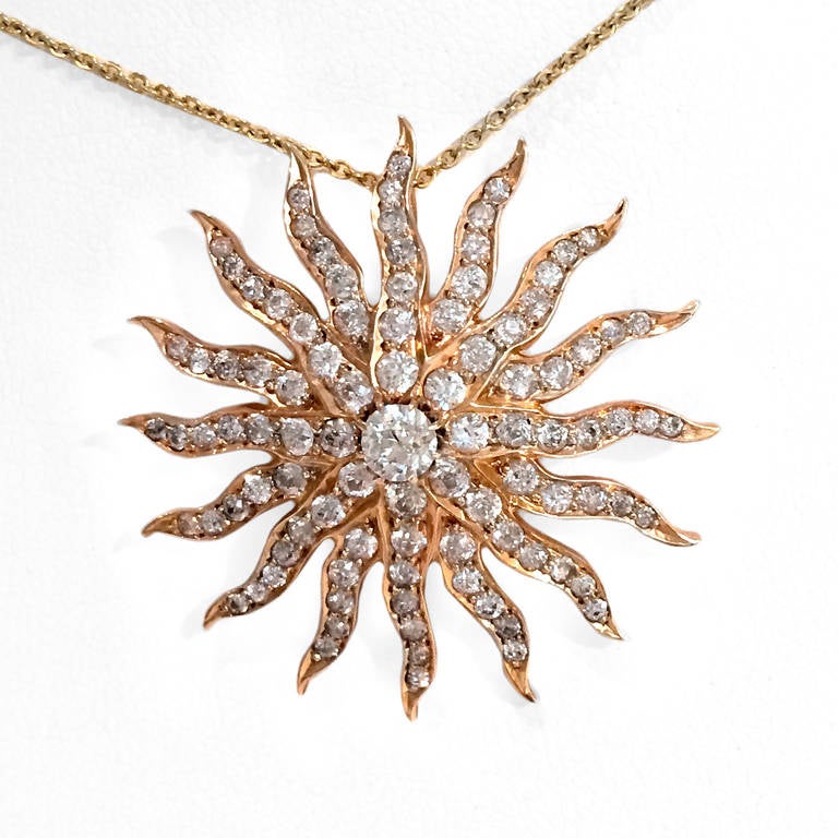 14k yellow gold contemporary sunburst pendant features 3 ct white, round-cut diamonds. 14k chain included.
