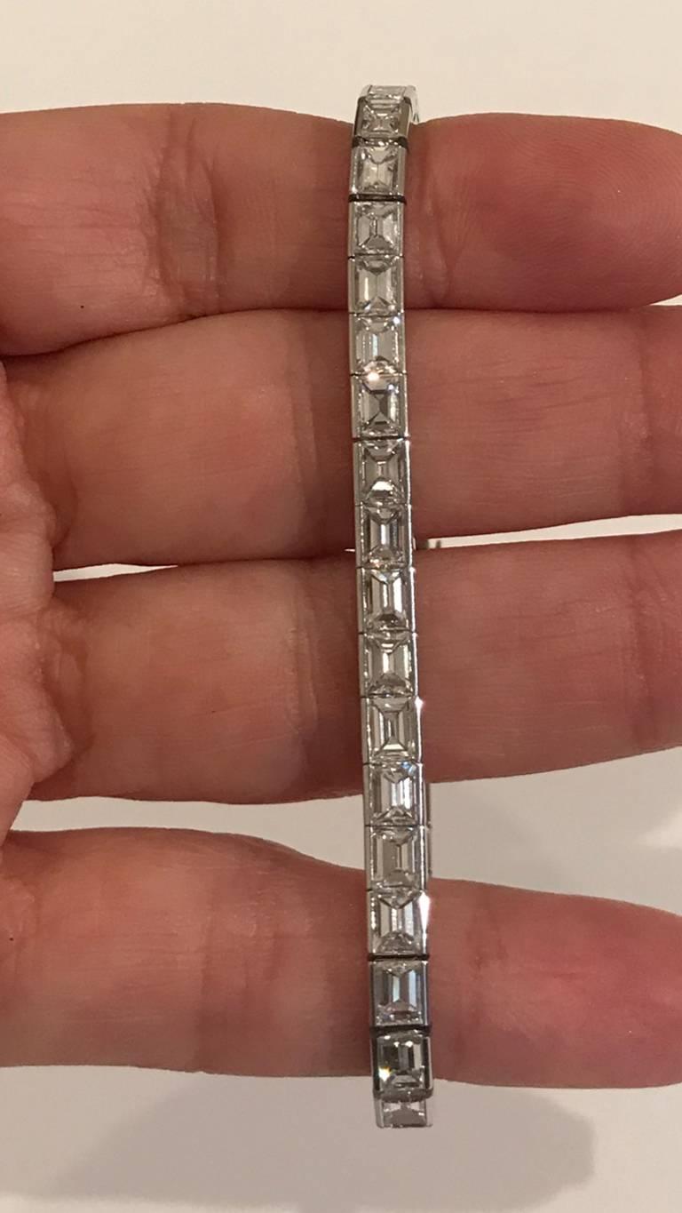 Cartier 13.25+ carat of E-F, VVS Emerald cut Diamonds set in Platinum. Signed Cartier. 43 Diamonds; 7