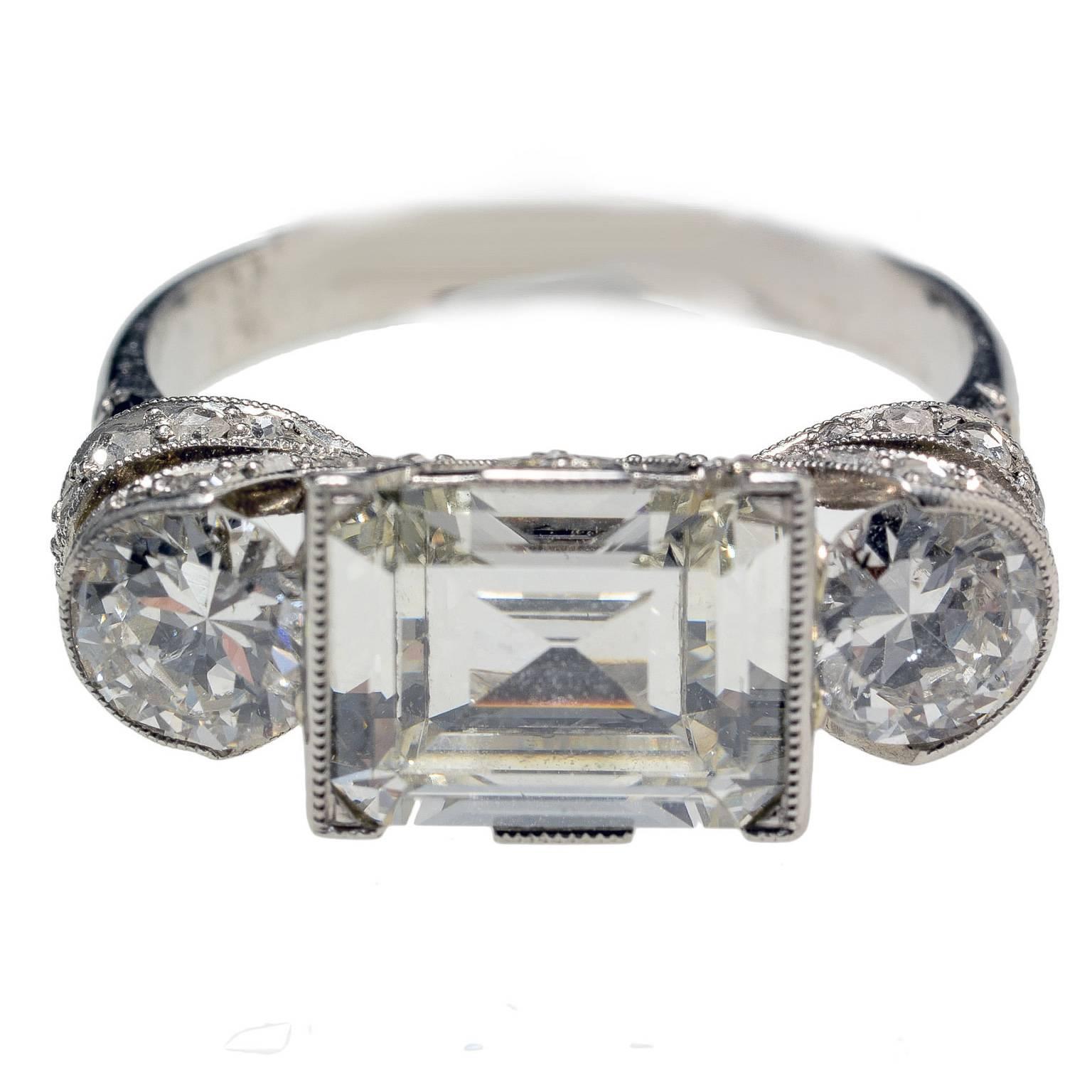rare art deco 1.70ct centre diamond three stone ring set with fine diamond shoulders and sides 1920c