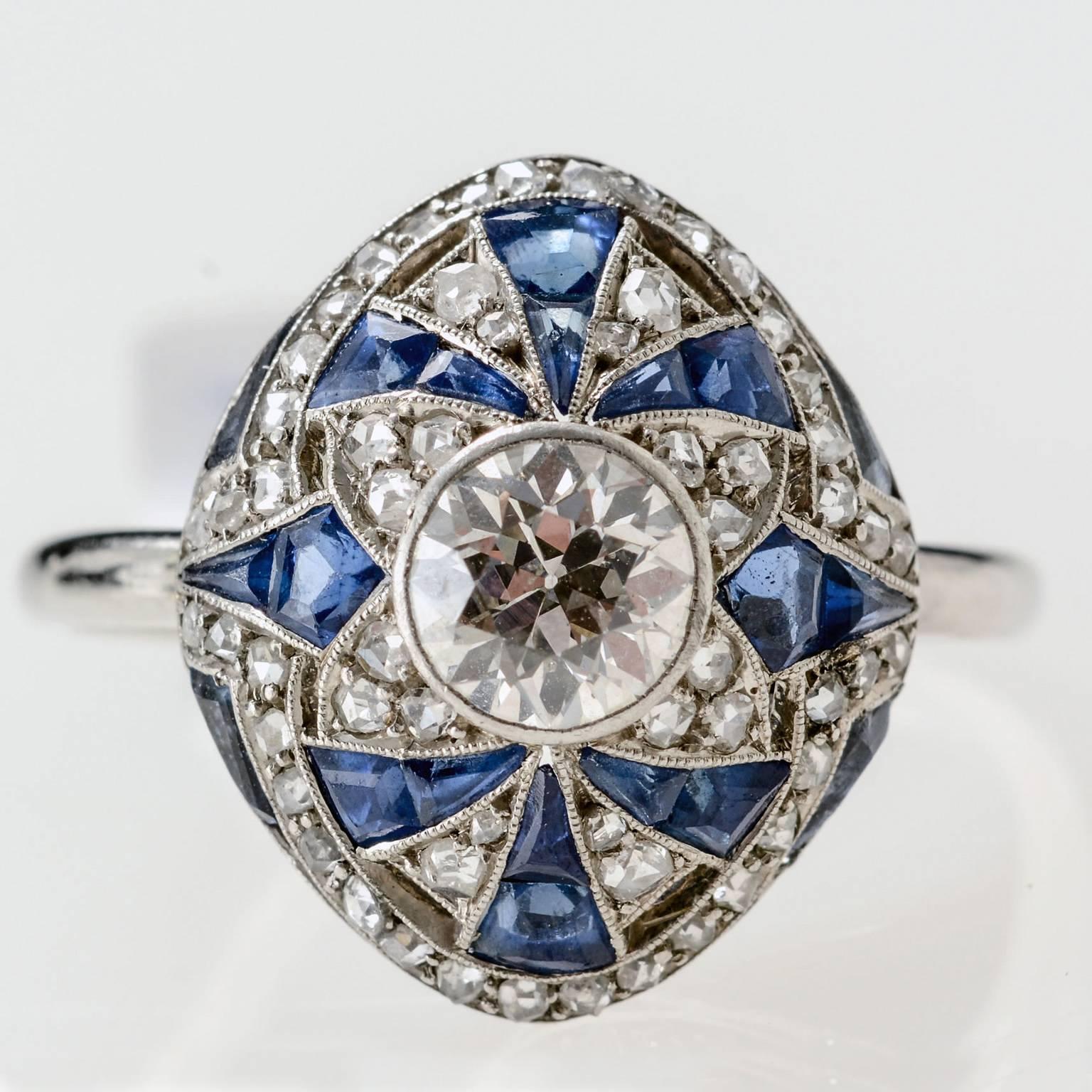 Natural unheated blue sapphires, rose cut diamonds with an approximate .60 pts Edwardian cut diamond centre stone.
Ring Size: N (UK), 6 3/4 (US). Can be resized up or down if necessary.
