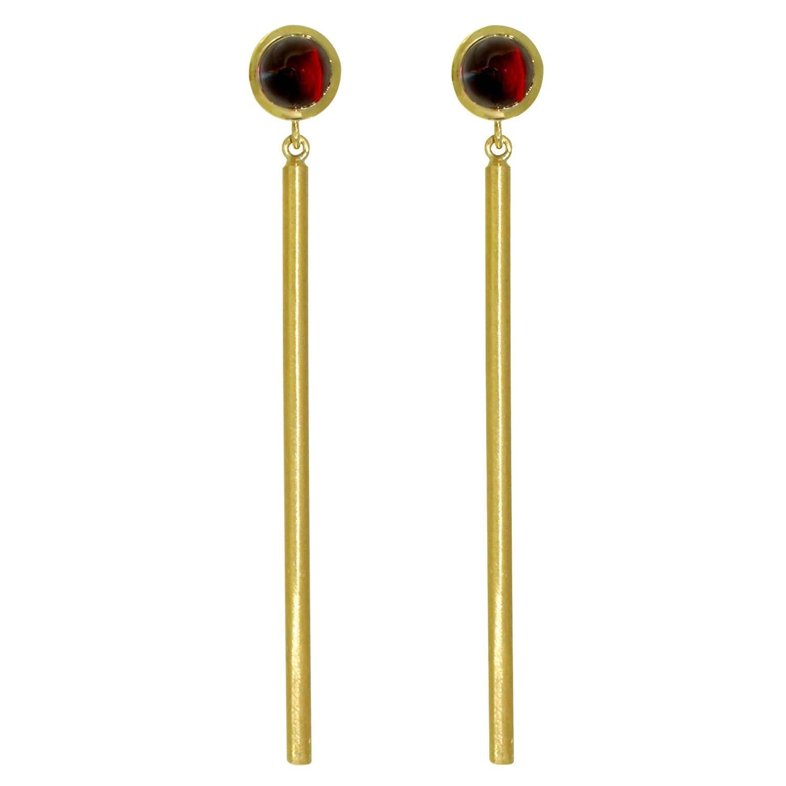 Warm glow of brushed 22 karat yellow gold makes these simple and elegant earrings a timeless classic. Inspired by Egyptian Art Deco revival architecture, and set with bullet cabochon rhodolite garnets, these earrings are sexy and sophisticated.