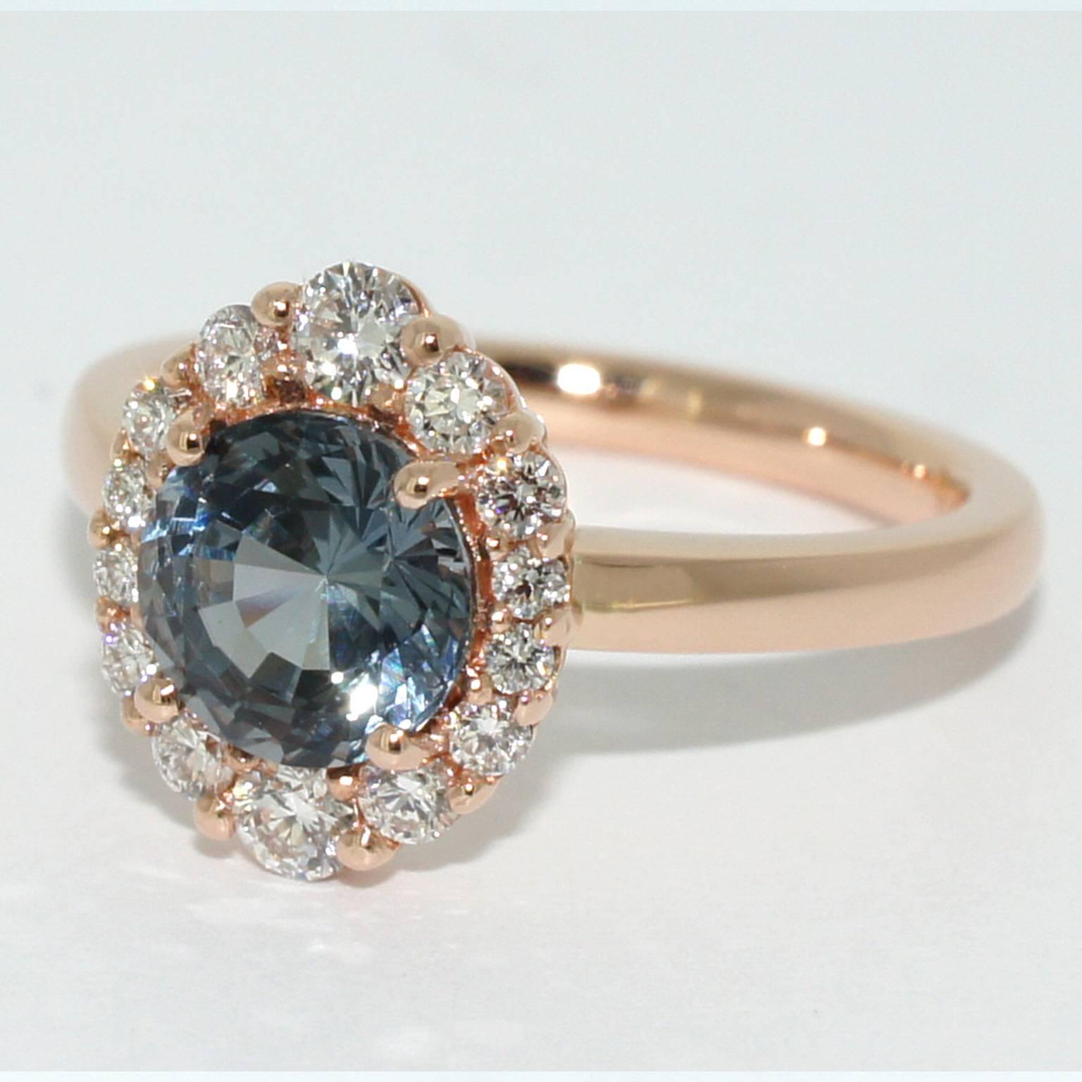 This gorgeous, feminine engagement ring is a modern take on a classic design. With a beautiful, sparkling 1 carat grey spinel as a central stone and 14 F VS diamonds in the halo, this contemporary engagement ring is made to order in our Sydney