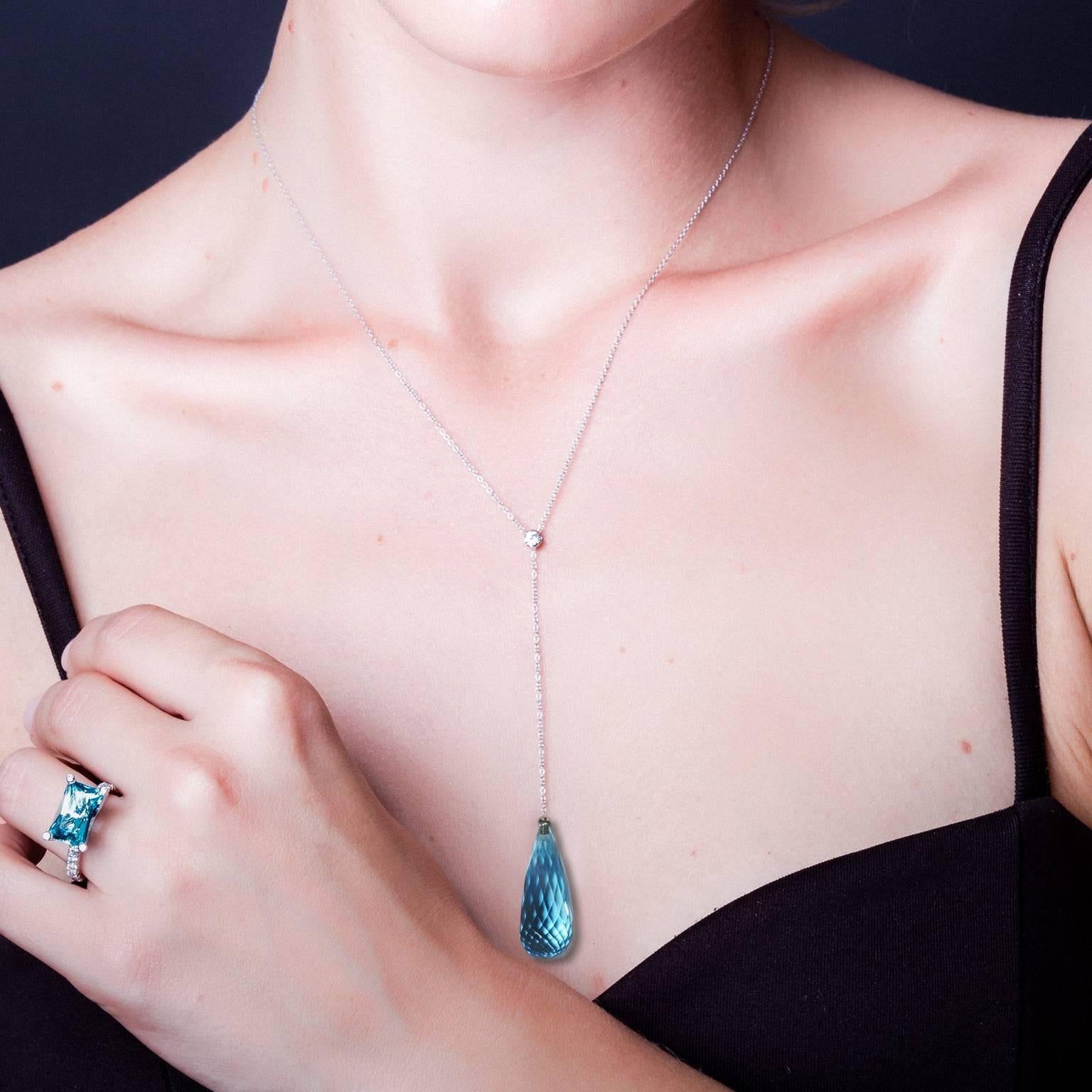 This gorgeous, elegant necklace is handcrafted in Sydney in 18k white gold and set with a sparkling natural blue topaz drop 14.86 carat, and a round brilliant cut white diamond 0.1ct FG VS. 

Necklace length can be adjusted. Current length 63cm.