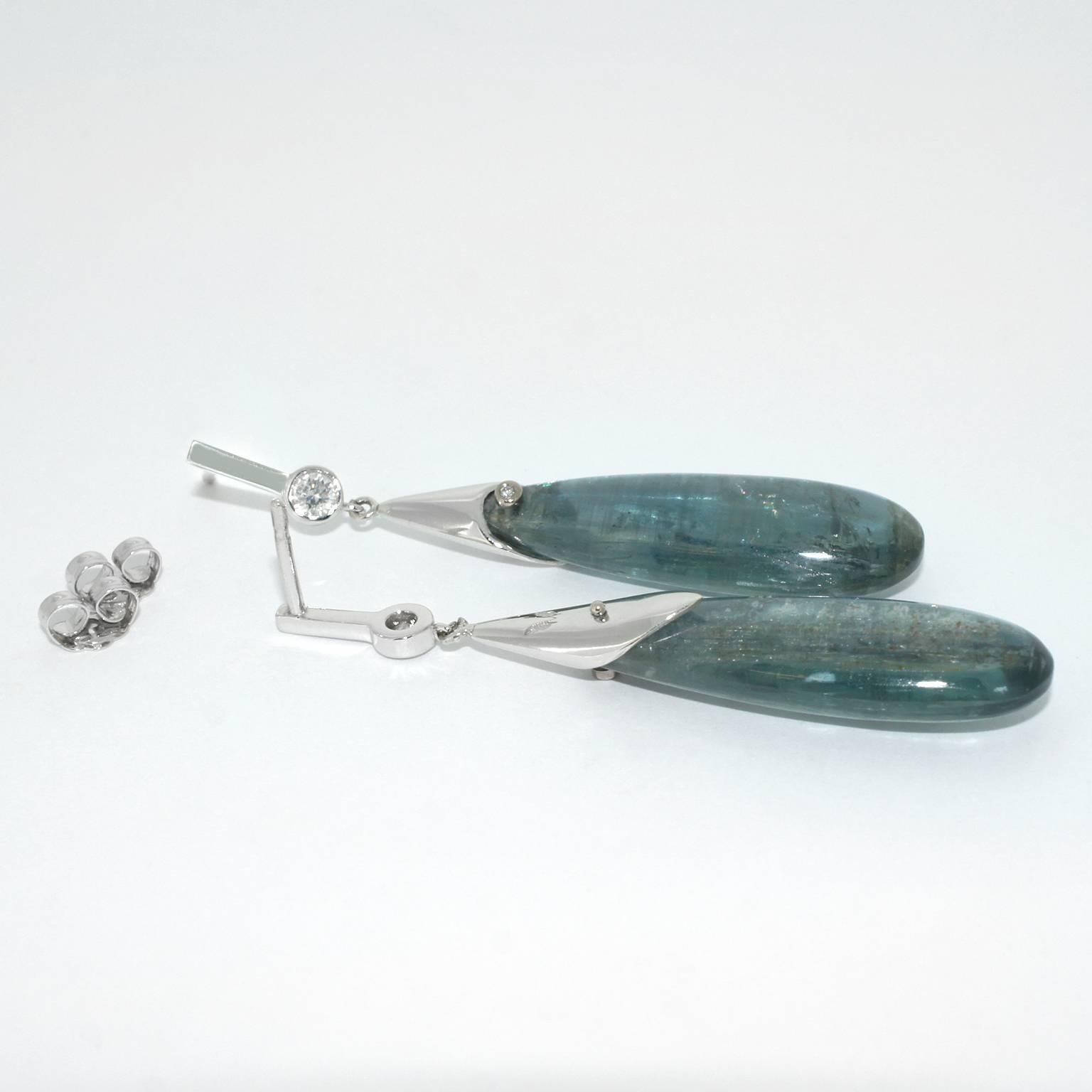 Raindrops were the inspiration behind these blue-green kyanite and diamond drop earrings. Kyanite is a gorgeous exotic gemstone with unique natural markings. Its name derives from the Greek word 'kyanos', which means 'blue'. Kyanite is said to have