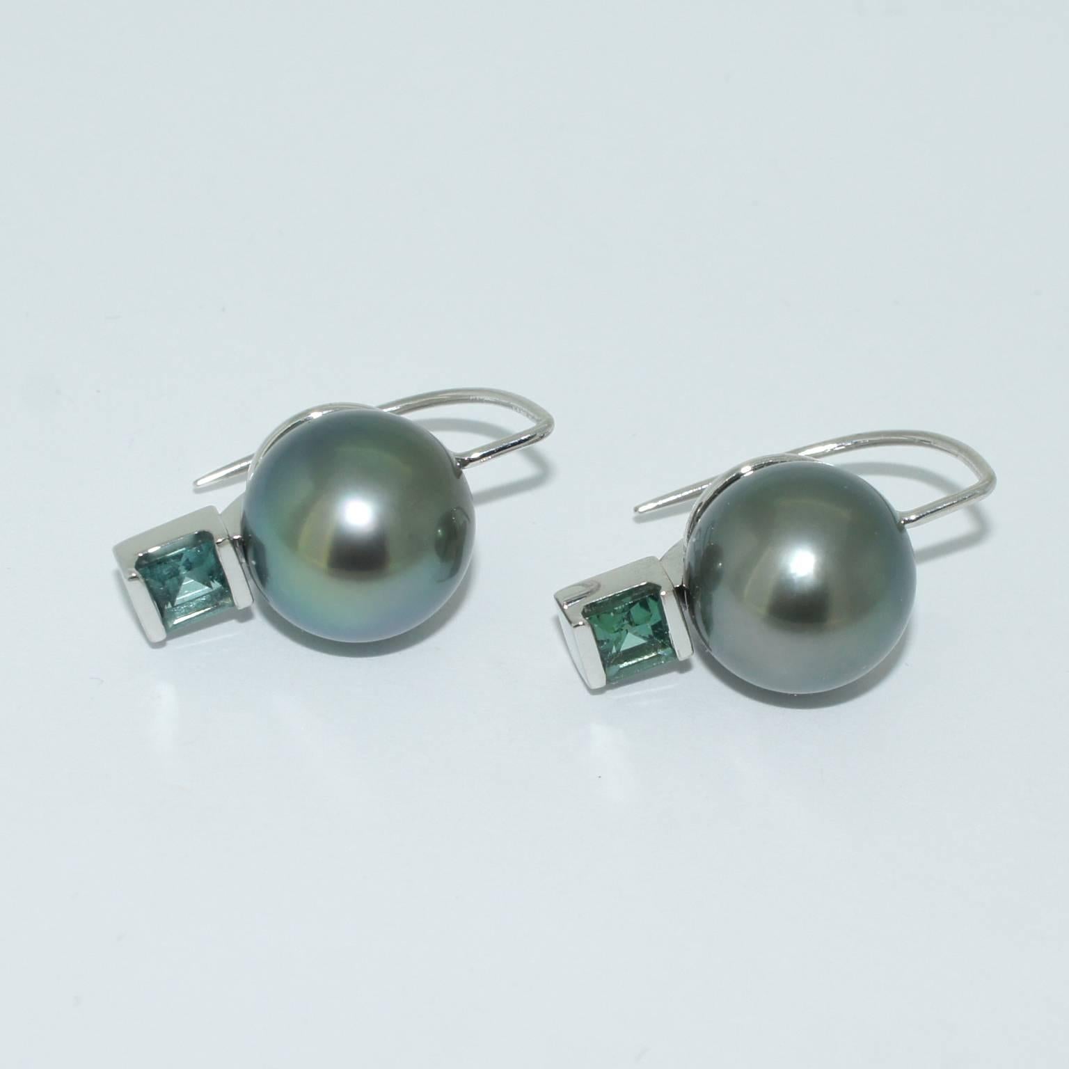 These elegant pearl earrings are handmade in our Sydney studios in 18 karat white gold, and set with a pair of natural grey Tahitian pearls of excellent lustre and colour and two square cut natural teal tourmalines. Infinitely wearable from day to