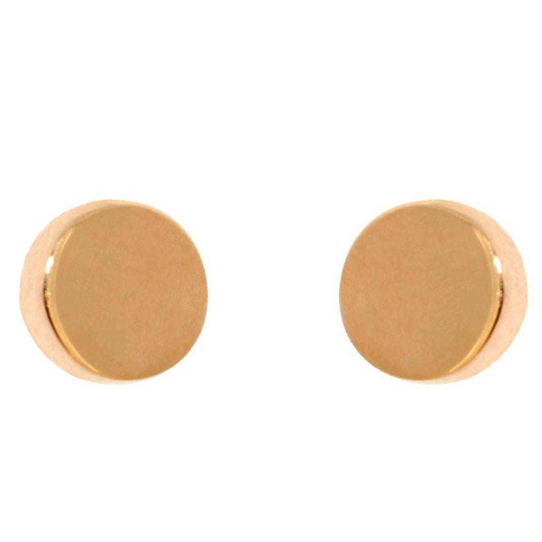 These minimalist, geometric earrings' design was inspired by clean lines of geometry. With one side of the disc thicker than the other, these simple, elegant earrings are versatile and infinitely wearable. These earrings are handcrafted in our