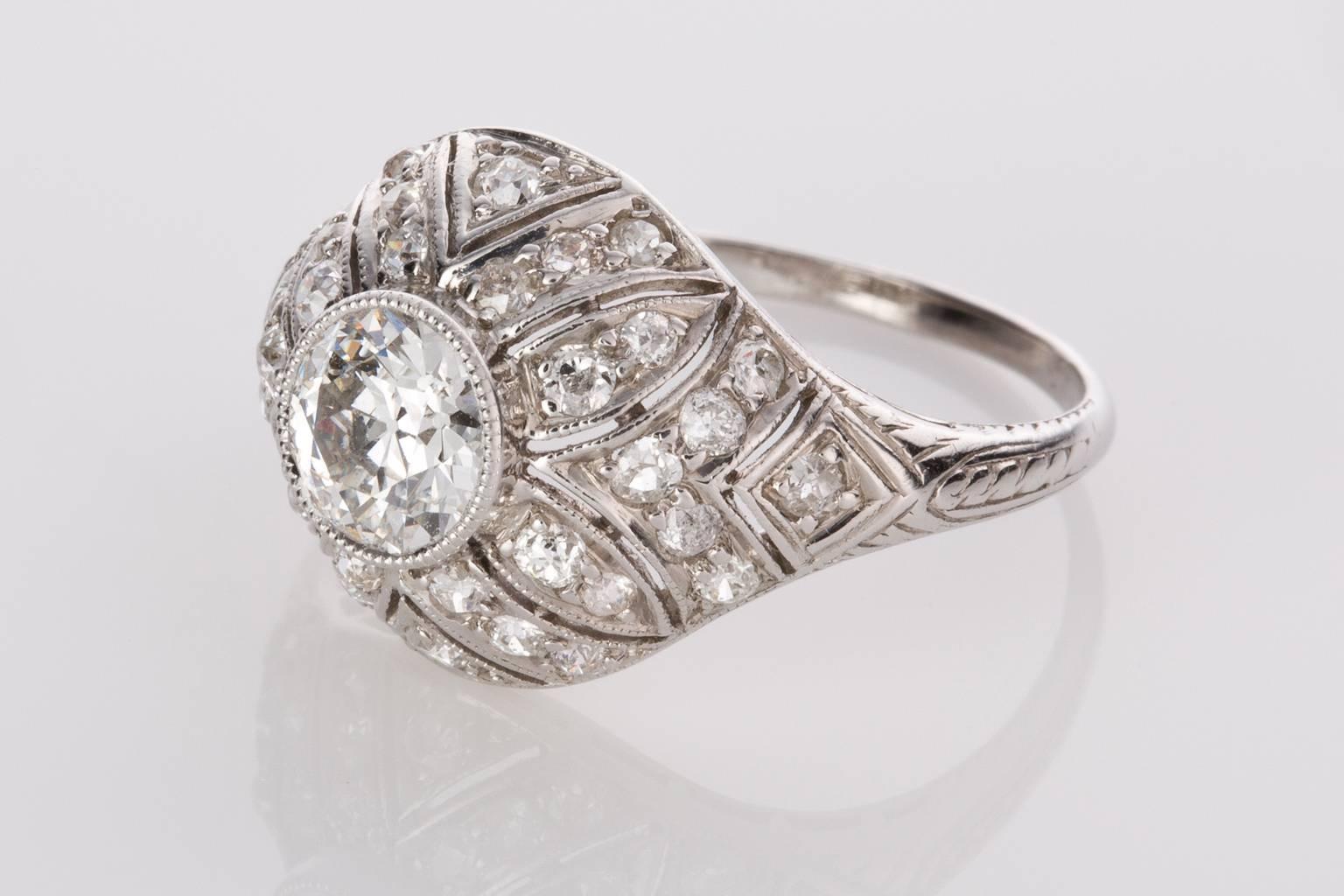 This ring is a total knockout! A fabulous original Edwardian filigree ring set with a central old European cut diamond weighing 0.81cts H colour, SI1 clarity,  accented with intricate filigree detailing working outwards in a floral pattern