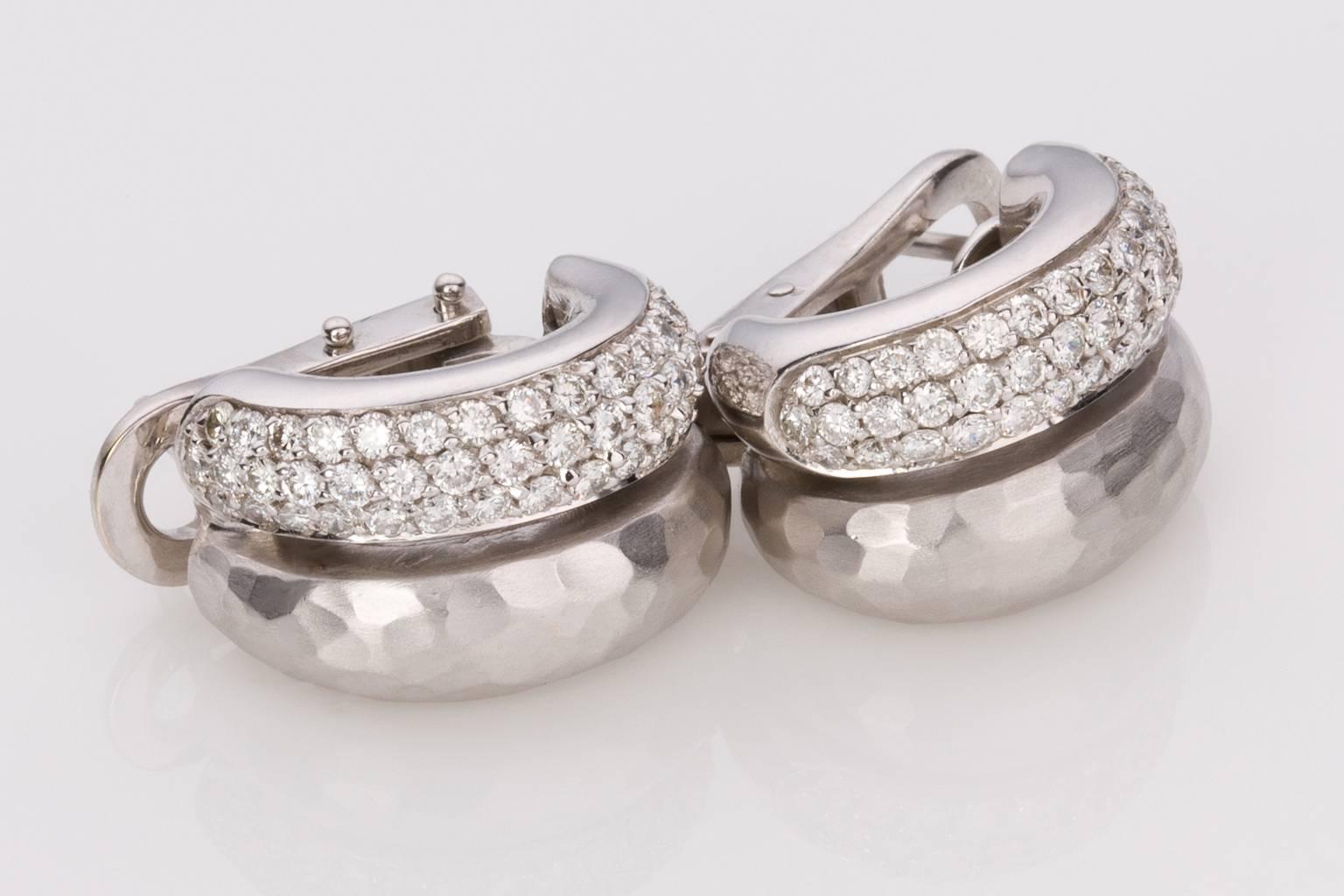 A beautiful pair of hallmarked 18k white gold "H Stern" double row hoop earrings, consisting of one hammered finish tubular hoop with a satin finish and one tubular hoop consisting of 43 pave set diamonds in each earring with an