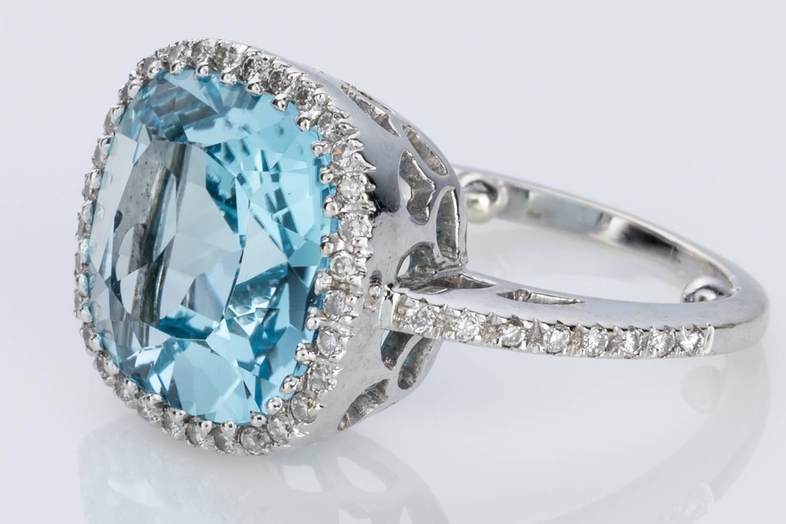 Contemporary Blue Topaz and Diamond 18 carat White Gold Halo Style Dress Ring