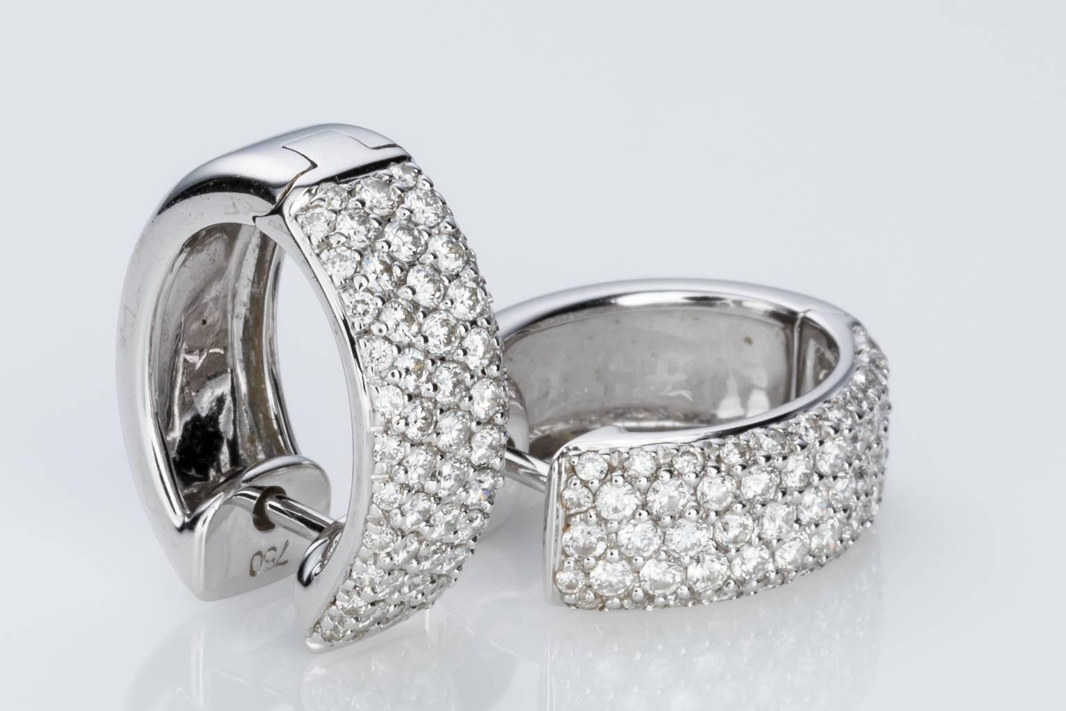 Sophisticated, elegant and great for every occasion, a beautiful pair of 18k white gold pave set diamond hoop earrings being 6.00mm wide, half round inform with each earring containing 56 brilliant cut pave set diamonds G/H colour, VS clarity with a