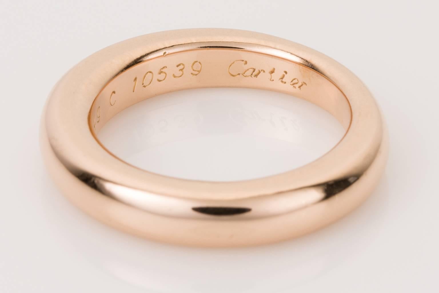 Simple & elegant this 18k rose gold band ring from Cartier makes a statement wedding band. Would look fabulous stacked next to other rings or with an engagement ring. 18k Rose gold is a nice look for something different, and the shape of this