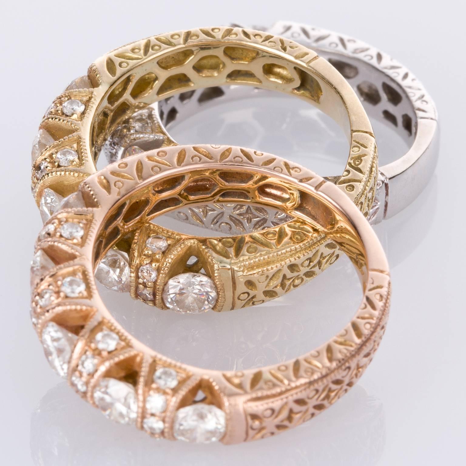 Looks great as a set of rings, but also individually these rings make a statement. A beautifully crafted 18k yellow gold eternity band with fine detailing including engraving down the shank, as well as diamonds set into the sides of the bands.