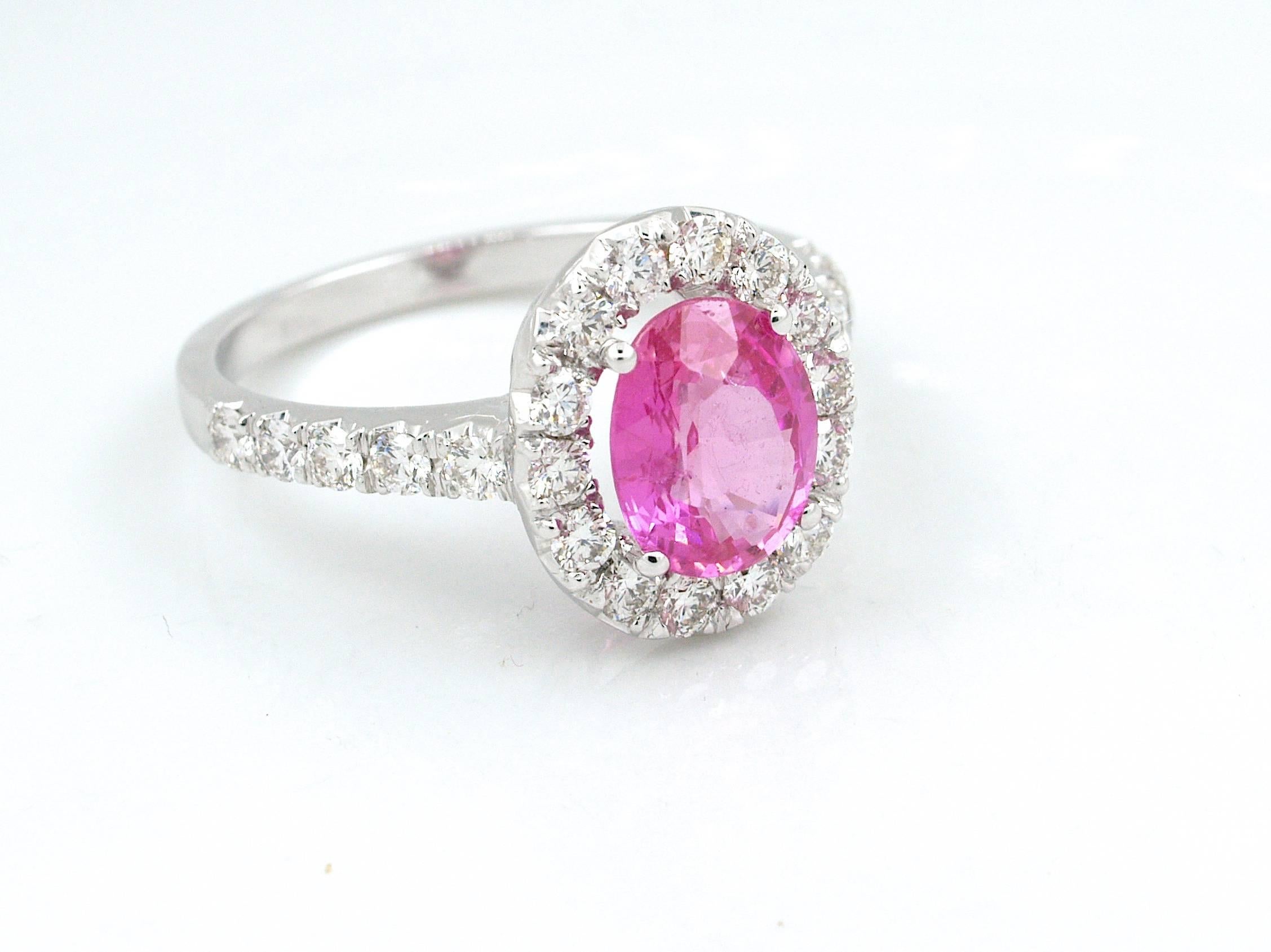 18k yellow gold ring featuring a natural pink sapphire weighting 1.61cts and accented by brillant  cut diamonds weighting  0.67 cts, G-H color, VS clarity.

An IGI Antwerp certificate indicates that the stone is not heated.
Beautiful pink
