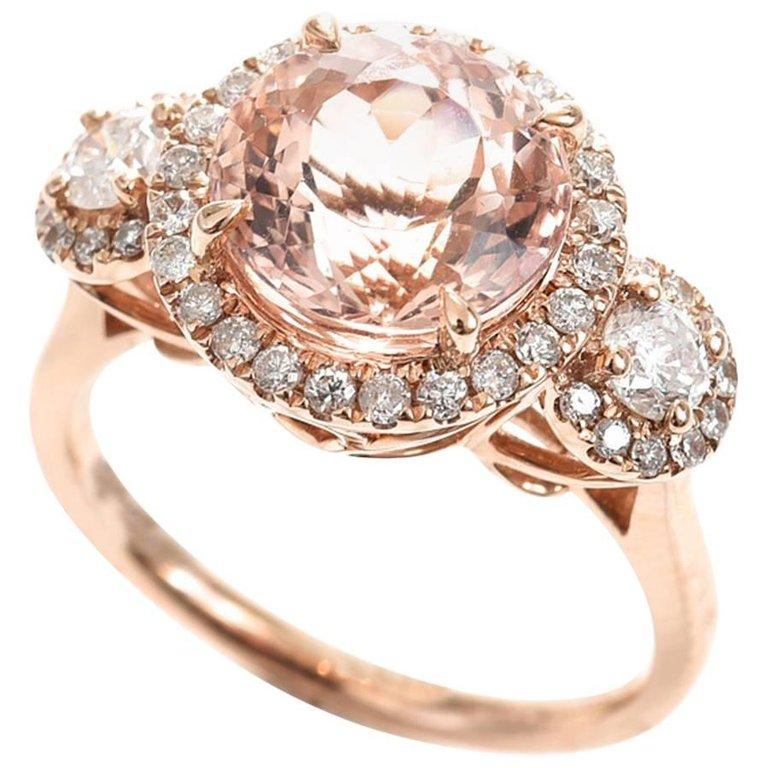 3.80 Carat Morganite and 2 Shoulder Diamonds in 3 Halos 18 Carat Rose Gold Ring by Cartmer Jewellery
	
One 3.80 Carat Morganite
44 Total Round Brilliant Diamonds 0.68 Carat
2 Round Brilliant Shoulder Diamonds totalling 0.31 Carat
42 Round Brilliant