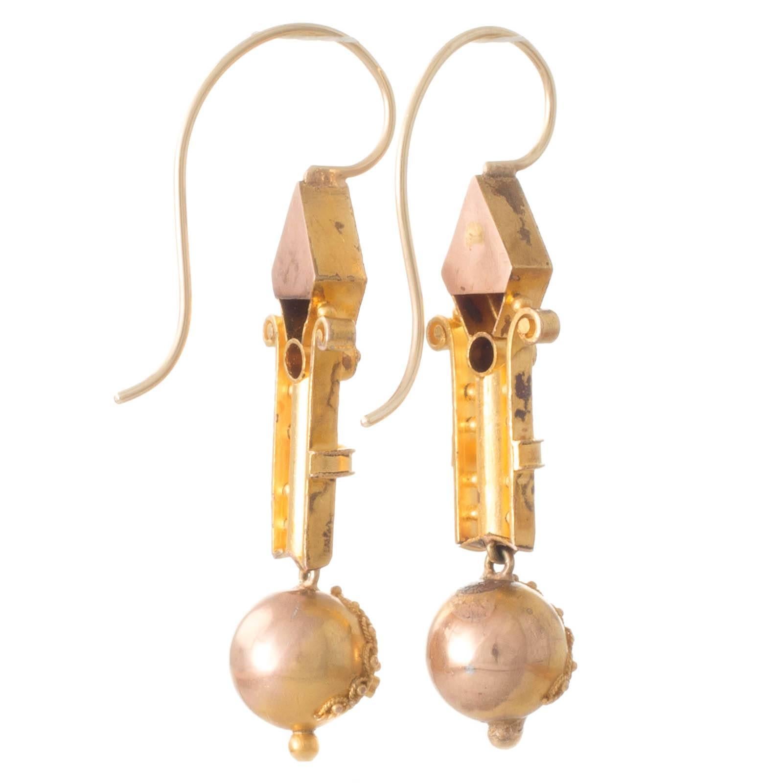 A pair of 15ct yellow gold mid Victorian earrings made in the Etruscan style each featuring a round ball at the base with applied gold wirework suspended beneath a long polished gold bar bordered either side by fine gold wires with scrolling tops