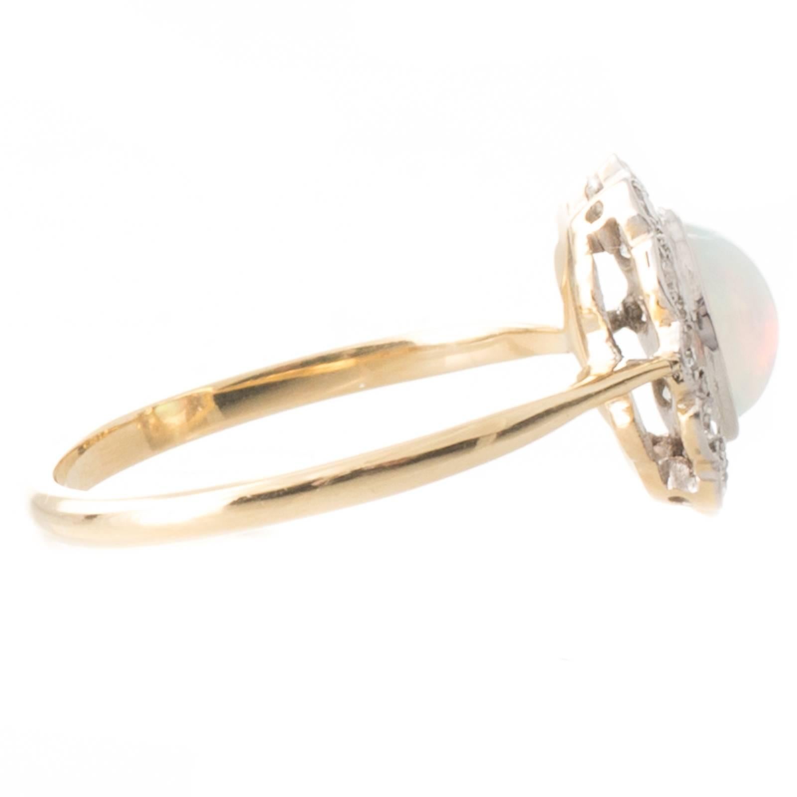 An 18ct yellow gold and platinum antique ring set with seven old cut diamonds in millegrain edging above a scalloped layered gallery to upswept spear point shoulders and a plain polished band. 
Total Estimated Diamond Weight: 0.75ct Colour H-I