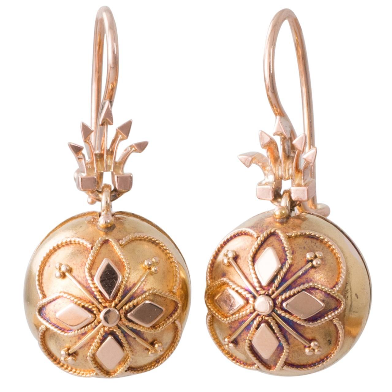 15ct rose gold earrings each with a claw set old cut diamond in a scalloped setting suspended from a decorative spiked top and a 10ct hook fitting with 15ct yellow gold bloomed coach covers a hinged round cover to wear over the diamond drops