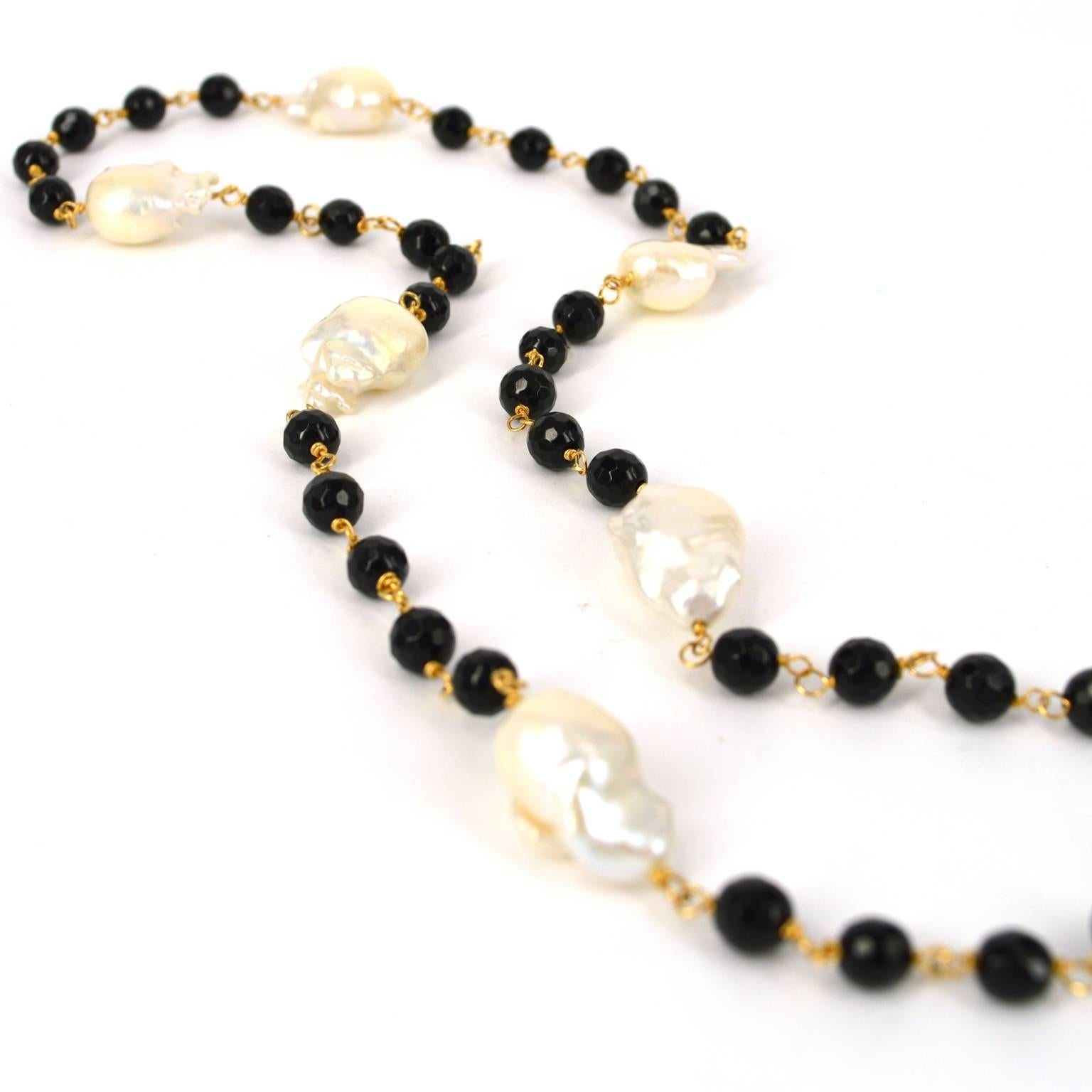 Individually hand wrapped with 14k Gold filled wire this necklace is a continuous strand of 5 x 6mm faceted onyx beads with 11 x 15mm+ Fresh Water Keshi Pearls. If you would like a clasp on this design or additional length please advise. Finished