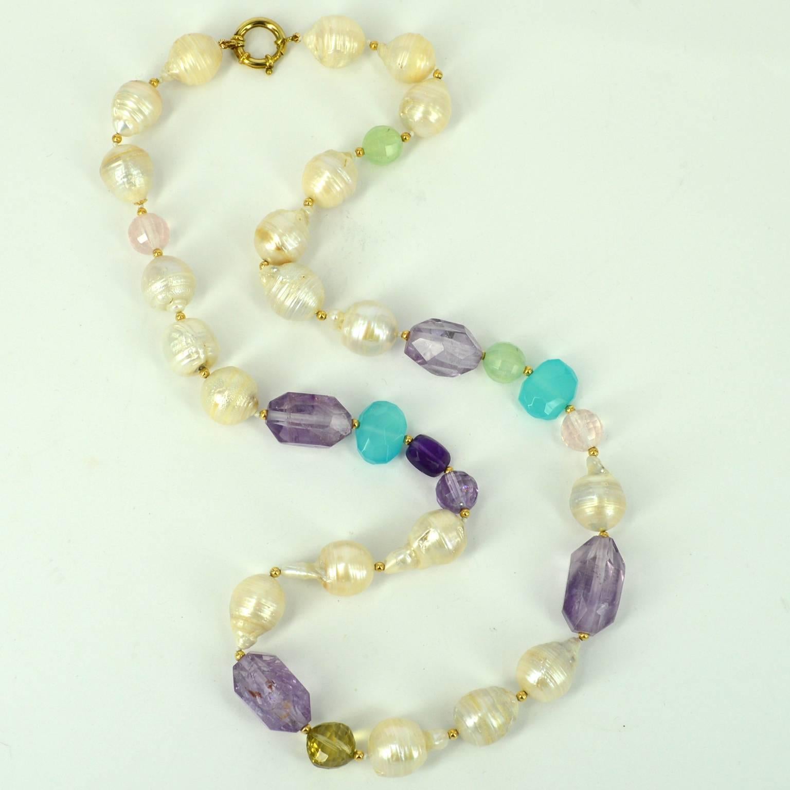 Long multi-hued necklace featuring Crinkled and circle Fresh Water Pearls, Light and Dark Amethyst, Rose and Lemon Quartz with a bright spark of Sea Blue Chalcedony. Hand knotted and spaced with 3mm 14k gold filled beads and finished with a 16mm