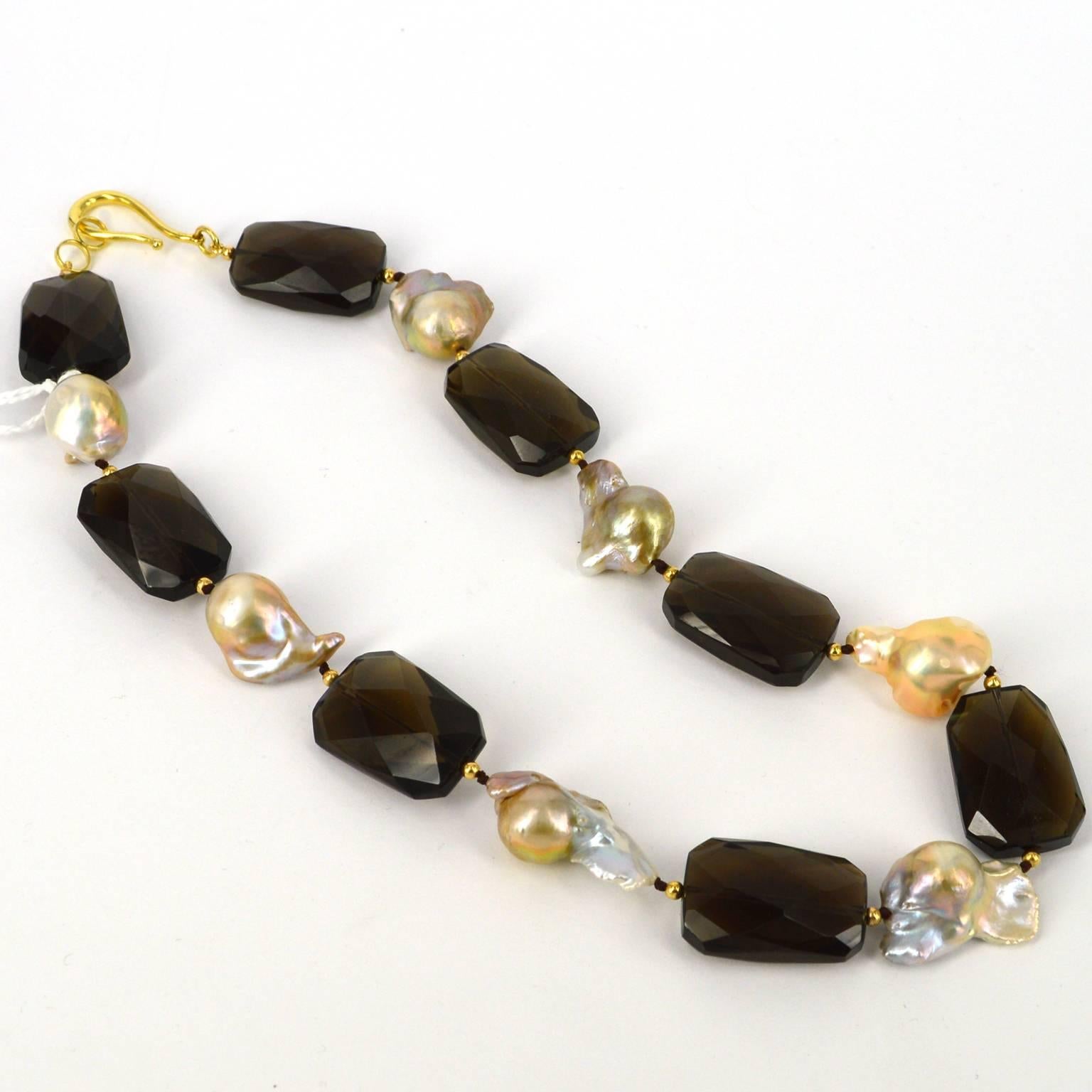 28x18mm unusual shaped faceted Smokey Quartz and naturally Pink Baroque 20mm+ Fresh Water Pearls with 3mm 14k Gold Filled Beads and a easy to use 29mm Gold Plate Sterling Silver hook Clasp. Finished necklace measures 50cm.

All stones and pearls are