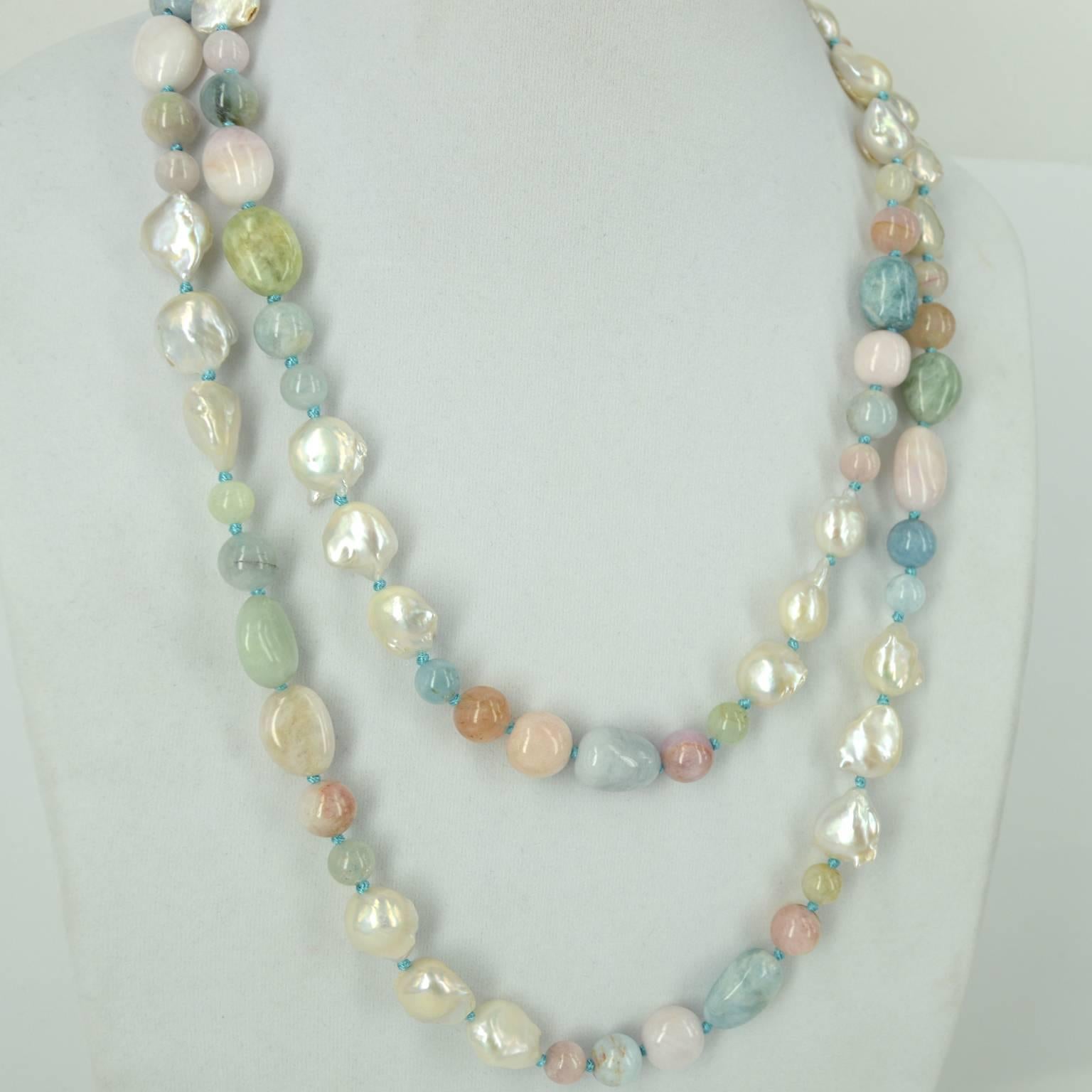 Pastel shades of Beryl in blue, pink and mint with creamy 14mm Fresh Water Keshi Pearls and a 9mm Round Sterling Silver Clasp are found in this beautifully hand knotted necklace. Small Beryl beads are 8mm round large round beads are 10mm round. Long