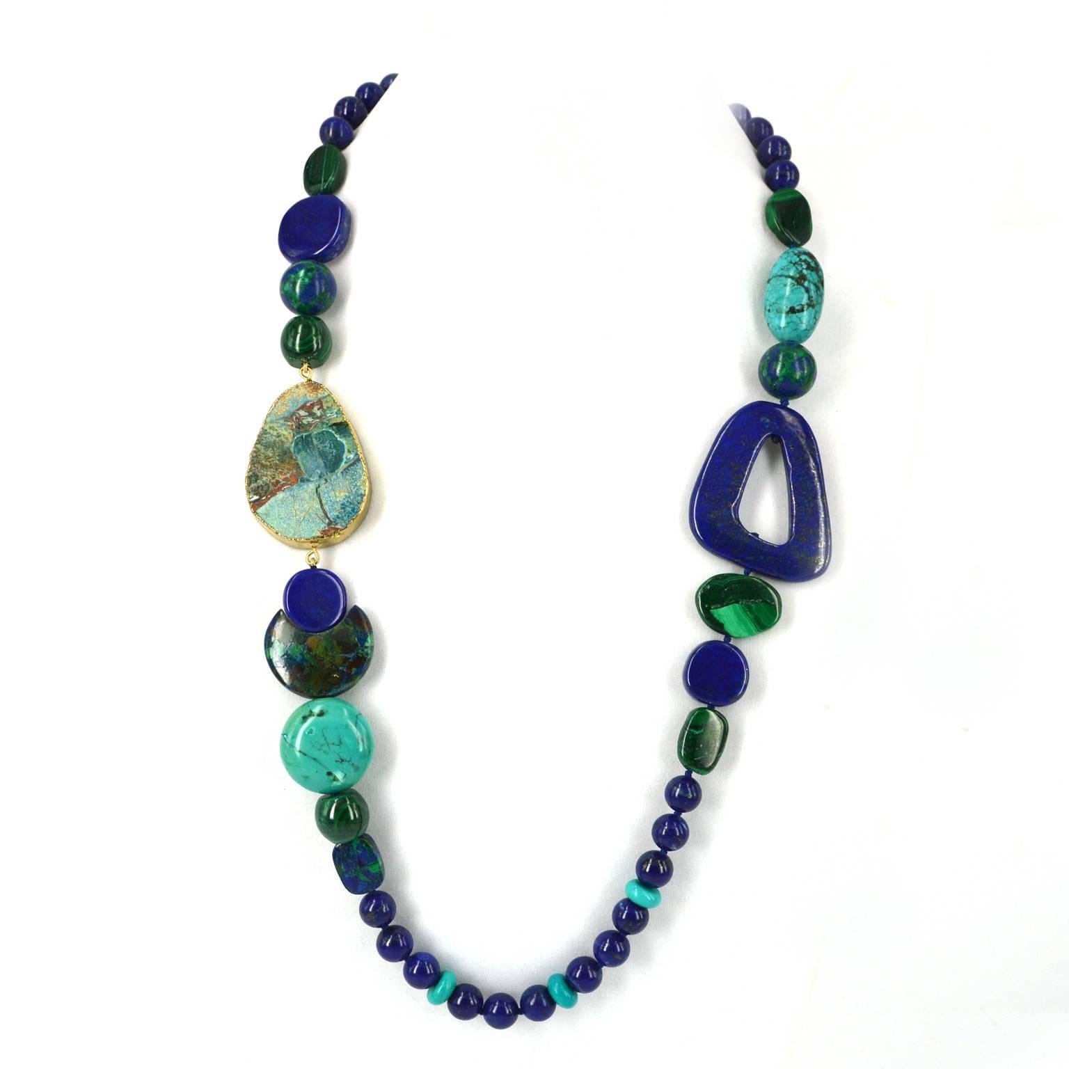 With tones of blues and green this Asymmetrical long necklace is made up of the most beautiful natural stones.
With two feature beads of Lapis and Jasper followed by high quality polished malachite and matrix turquoise with a dash of