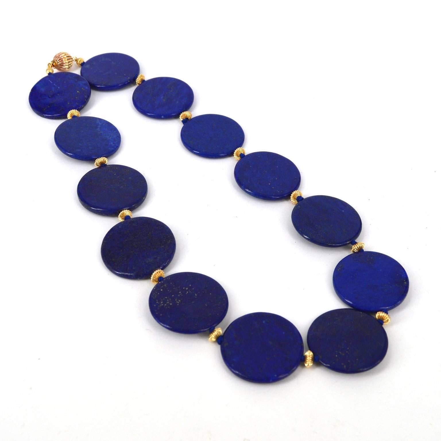 30mm polished flat disk Lapis Lazuli beads hand knotted on blue thread with 14k gold filled corrugated roundels and a 14k gold filled corrugated 14mm round clasp.
Total length of necklace 48cm.

All stones are natural and as such may include natural