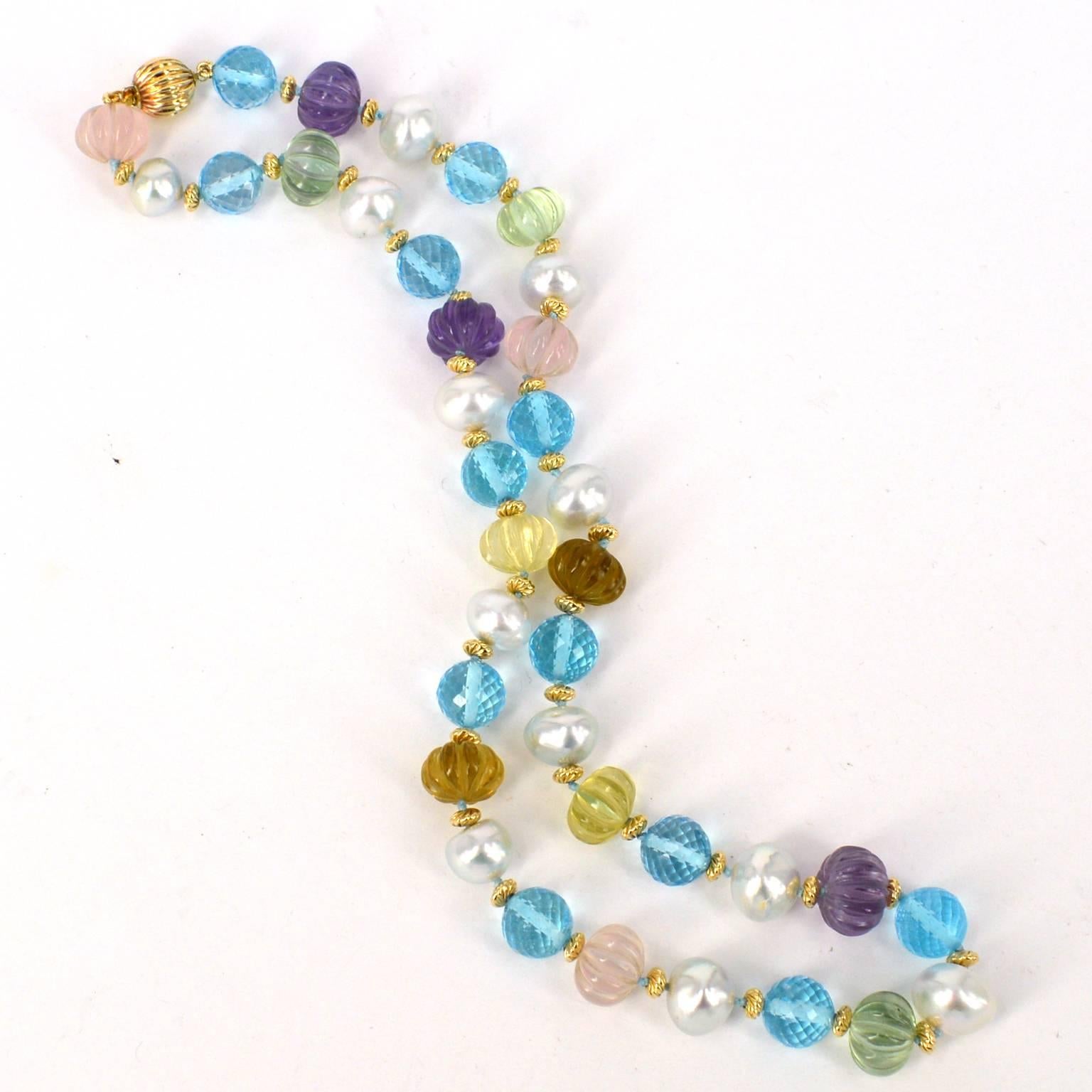 Stunning necklace made from approx 8x10mm Roundel shaped South Sea Pearls, 10mm multifaceted Blue Topaz beads and hand carved Amethyst, Green Amethyst, Rose Quartz, Beer Quartz and Lemon Quartz roundels. Carved roundels measure between 10-11mm x