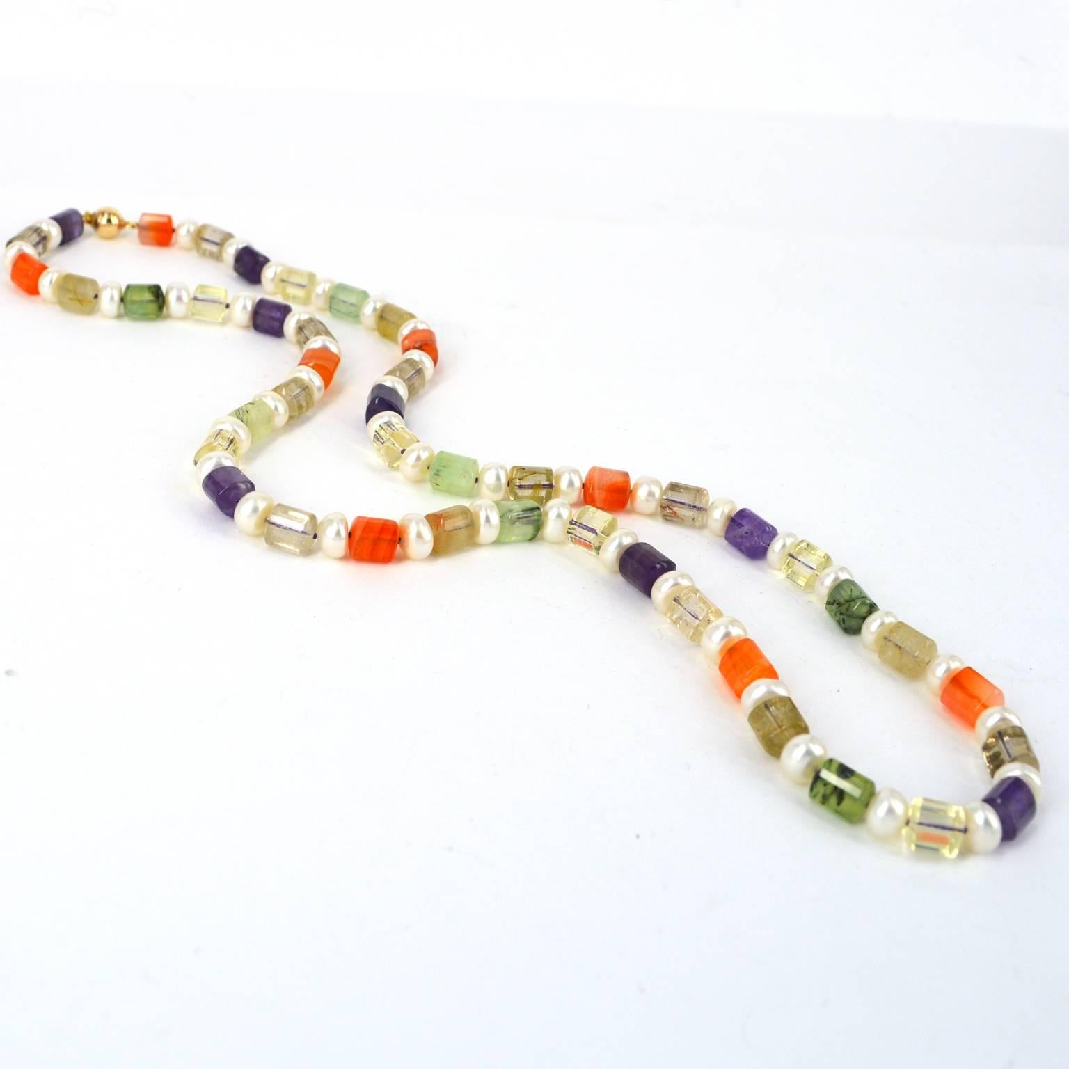 Delicate 8mm Faceted Triangle tube beads of Amethyst, Carnelian, Tourmalated Prehnite, Citrine and Rutile Quartz spaced with 8mm Fresh Water button Pearls. Hand knotted on purple thread with a 8mm 14k gold filled clasp.
Finished length of necklace