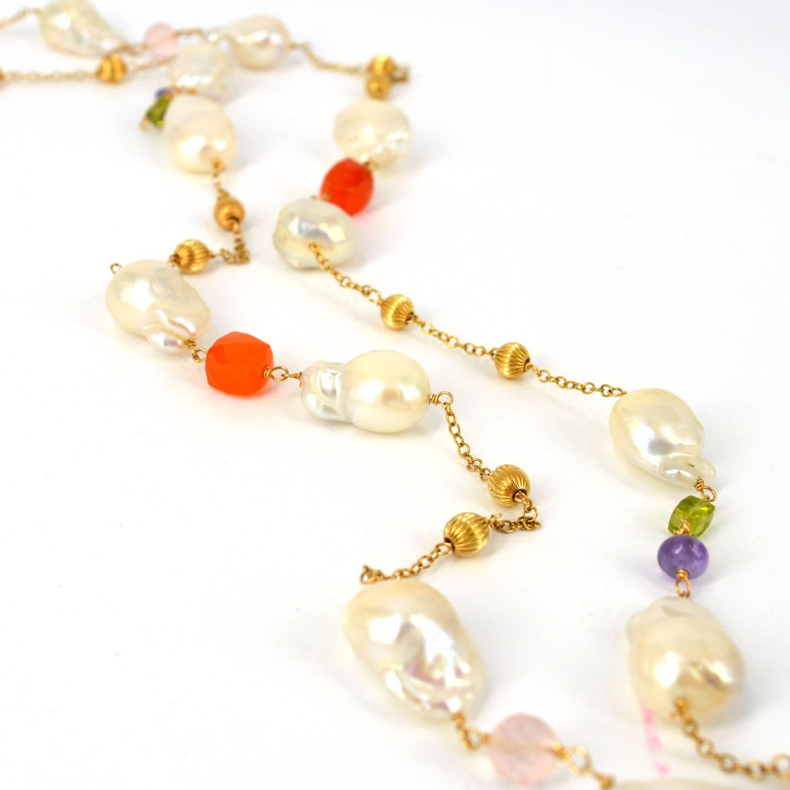 Stunning 14k Gold filled long necklace with Freshwater Keshi Pearls and gemstones. Carnelian 6mm faceted cubes Amethyst Peridot 4mm faceted cubes Rose Quartz and Blue Topaz 6mm faceted round beads. Freshwater pearls size is approximately 16mm. Each