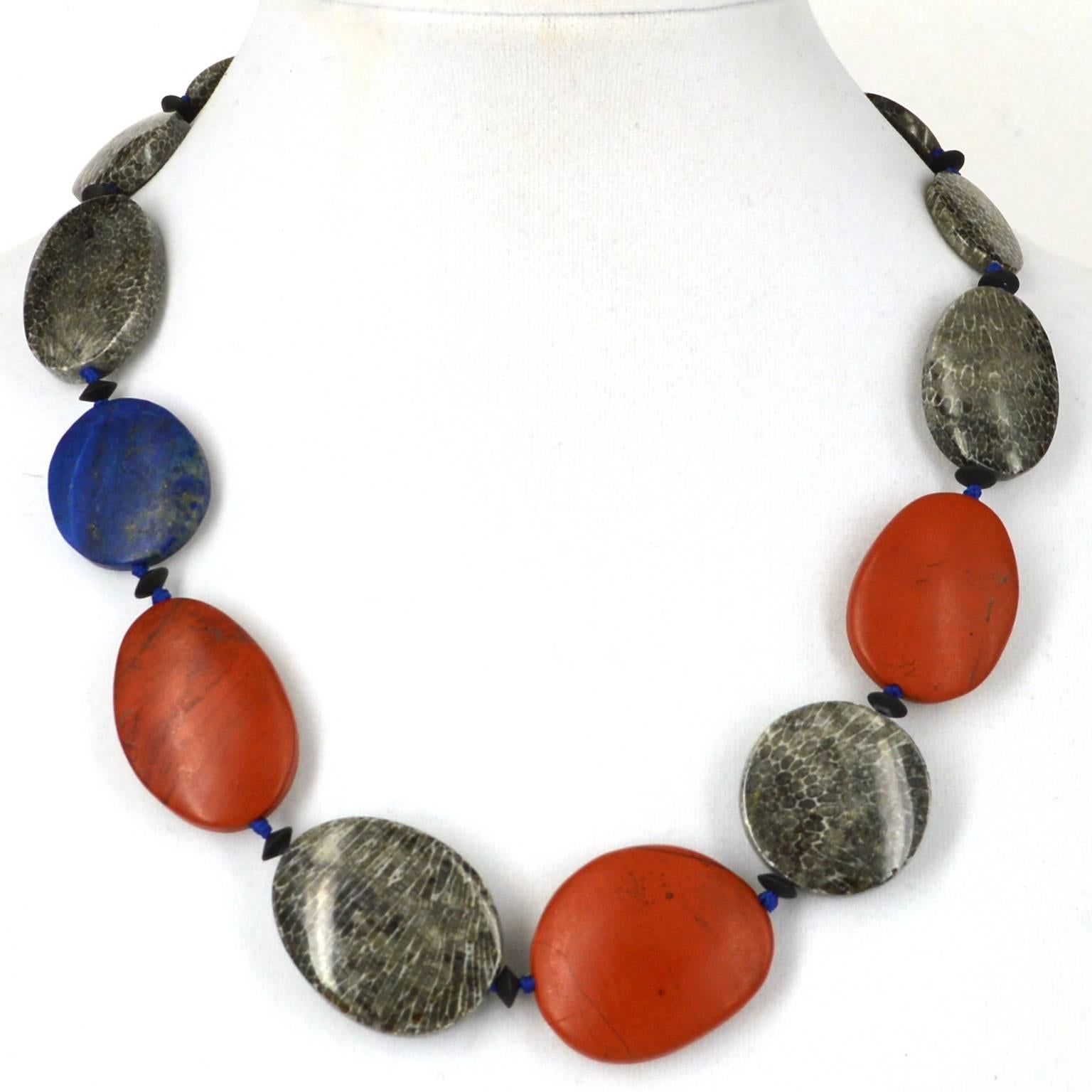Bryozoan fossil Coral flat oval beads ranging from 18.3x15mm up to 34x28.3mm 
with 3 flat oval matt Red Jasper beads measuring 31.6x34mm, 34.1x29mm and 35.3x24.4mm. The matt Lapis Lazuli bead is 26.2x23.7mm. Necklace is spaced with 6x3mm matt Onyx