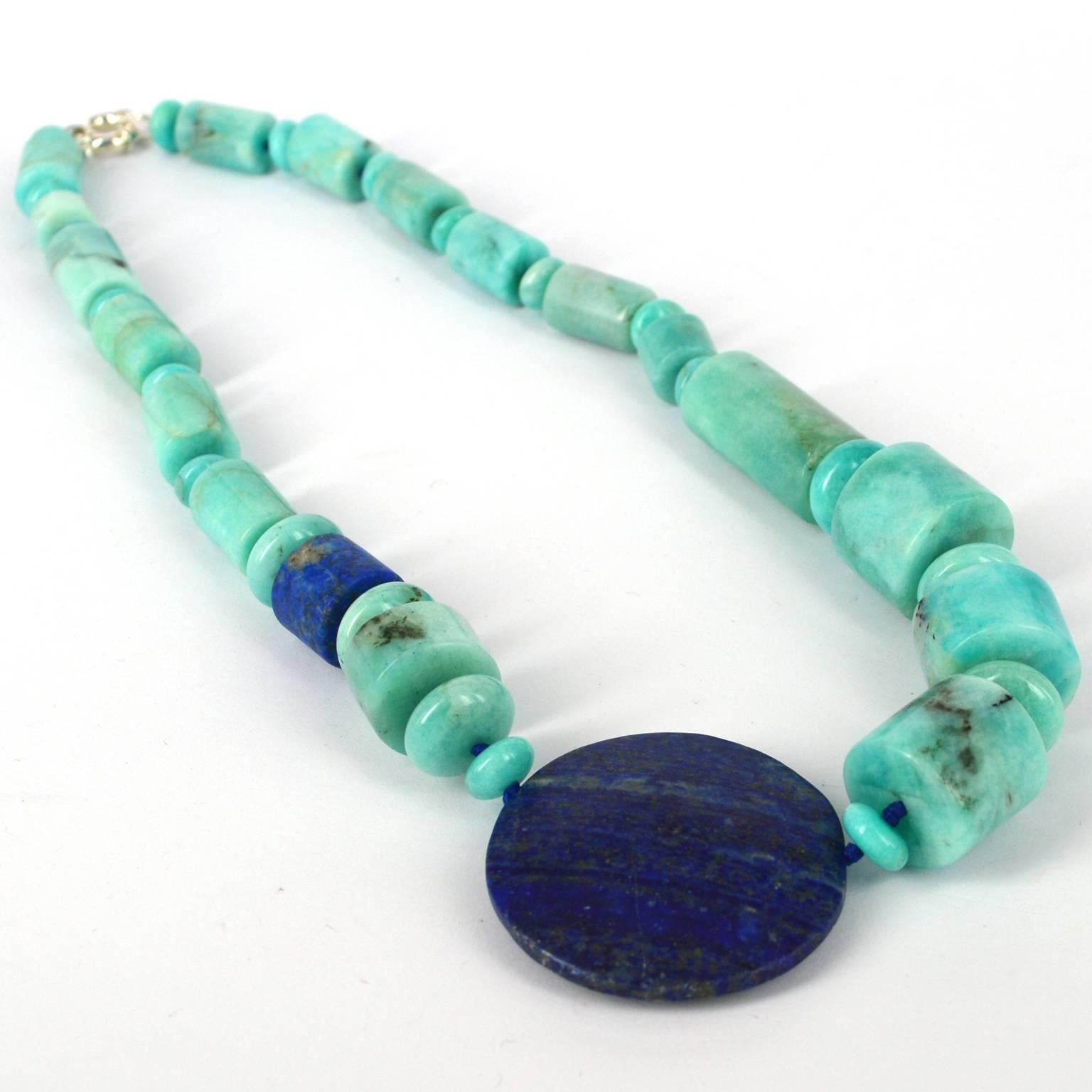 Round off-centre 45mm Drilled Matt Lapis Lazuli bead balances the Peruvian Amazonite Rondels and tubes. Amazonite tubes range from 12x18mm up to 20x18, knotted on Lapis Lazuli coloured thread with a 15mm Sterling Silver Bolt Clasp. 
Finished