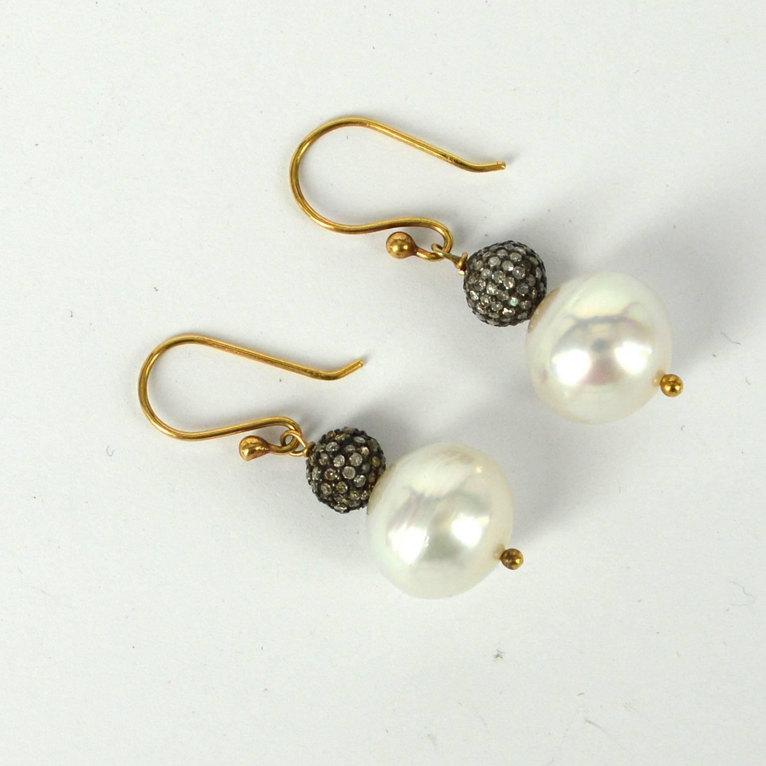 12mm High luster South Sea Pearls with 7mm Pave set Diamond Silver beads.
Sheppard and post are 9ct Yellow gold.
Earring drop 34mm.