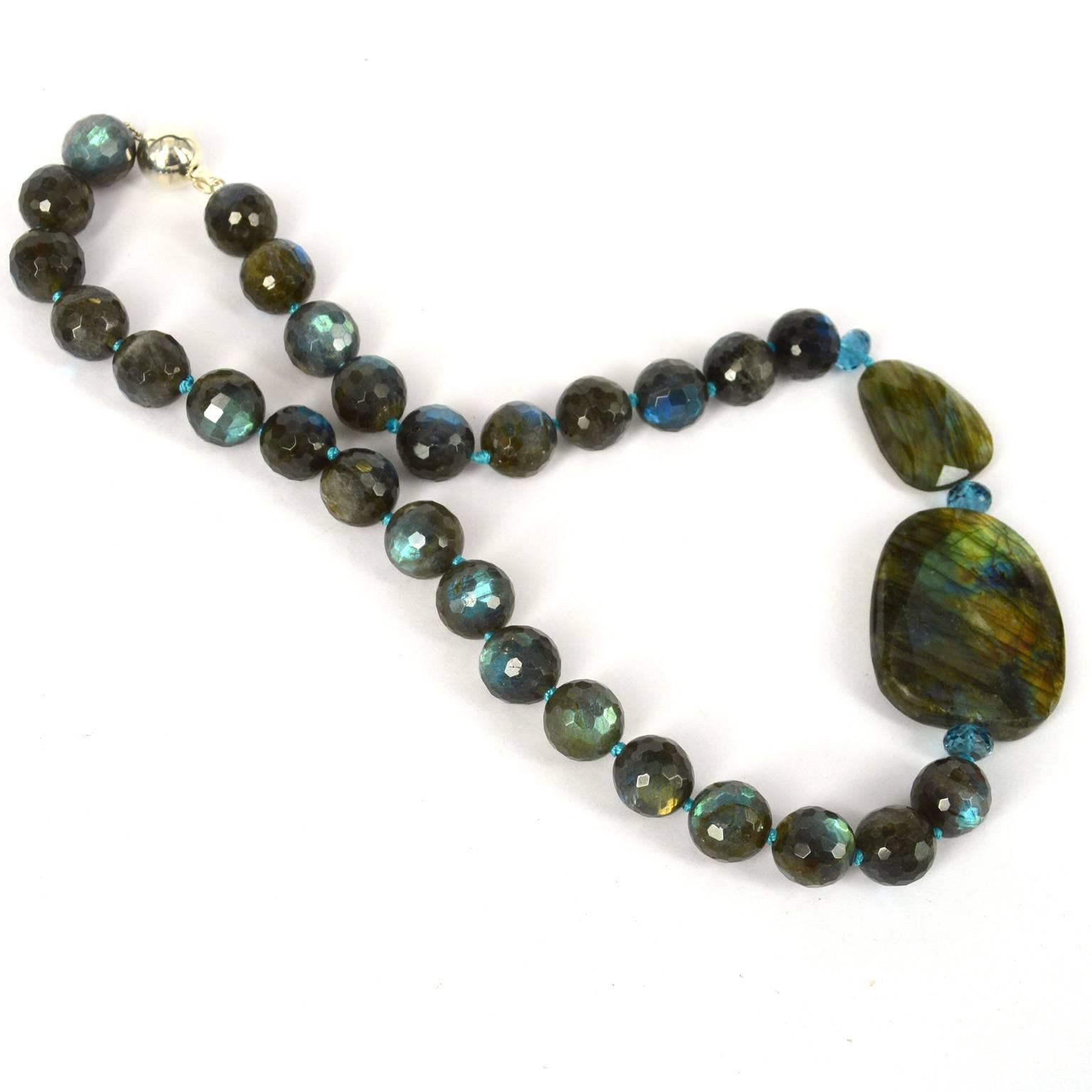 Flashes of blue abound in these high grade Labradorite beads, faceted round beads measure 13mm and the two Faceted nuggets are 20x27mm and 35x42mm. London Blue Topaz 8x4mm faceted beads further enhance this design. Knotted on blue thread with a 12mm