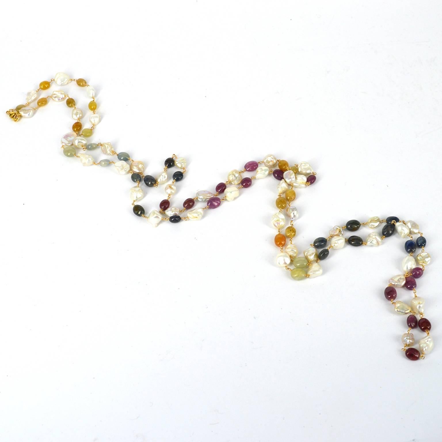 Natural polished multi color Sapphire nuggets 9x8mm with 9-10mm Fresh Water Keshi Pearls individually wire wrapped with 14k Gold Filled wire and a 14k Gold filled lobster clasp.
Finished necklace measures 145cm