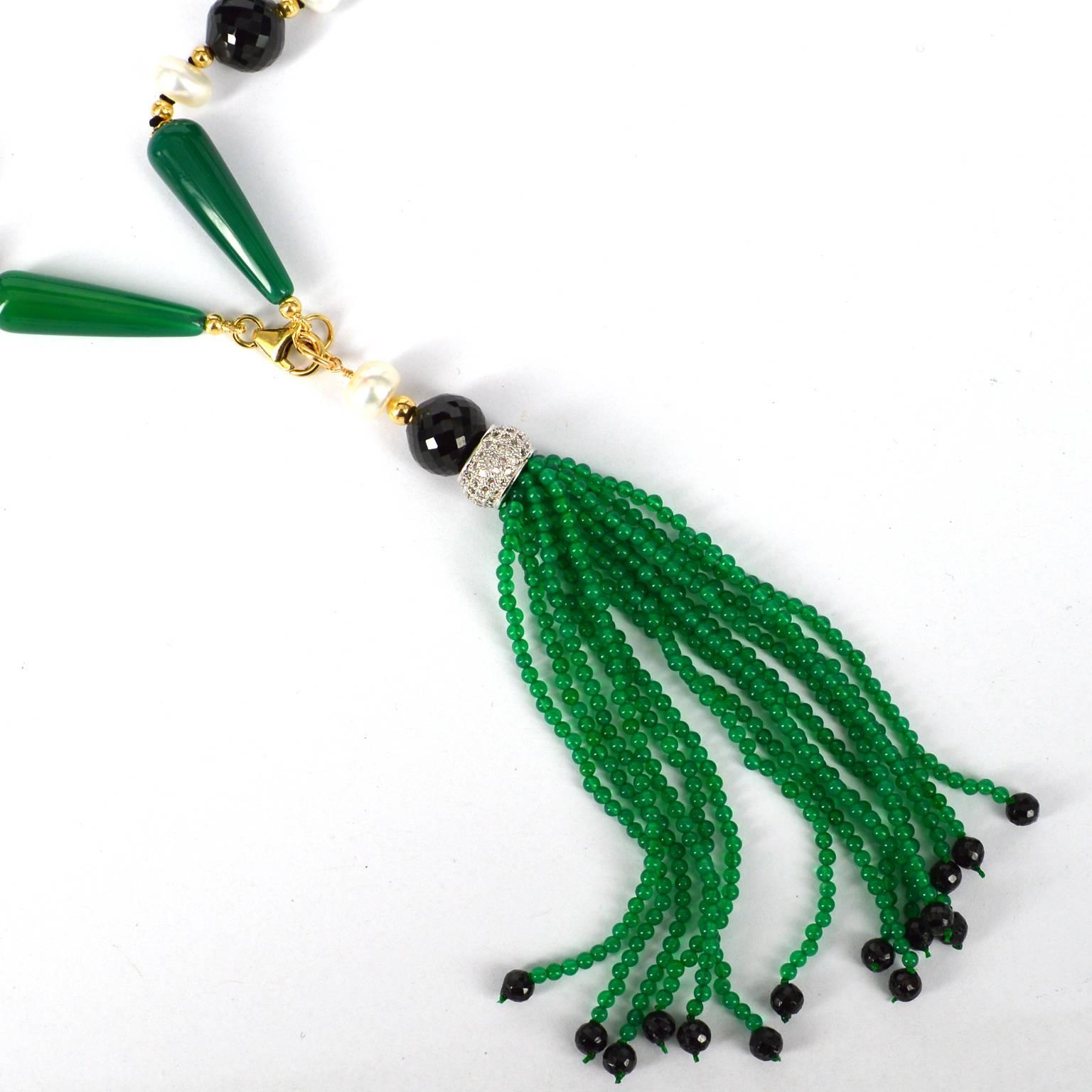 Art Deco style long knotted necklace with 8x28mm polished Green Agate teadrops, 10mm faceted round and 7mm faceted rondel Spinel beads, 8mm Fresh Water Button Pearls. 14k Gold filled 3mm beads, caps and clasp. Tassel is 15 strands of 2mm Green agate