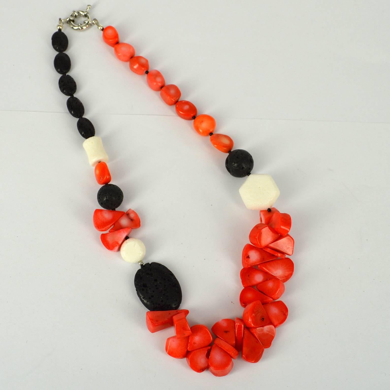 Orange Sea Bamboo Coral Orange teardrops approx 15mm with nuggets 8x12mm , Lava beads 14, 16mm , 28x21mm flat oval bead, and 14x8mm fat oval beads and White Coral beads 20mm Hexagon, 14mm flat oval and 14mm concave tube beads. Necklace is spaced