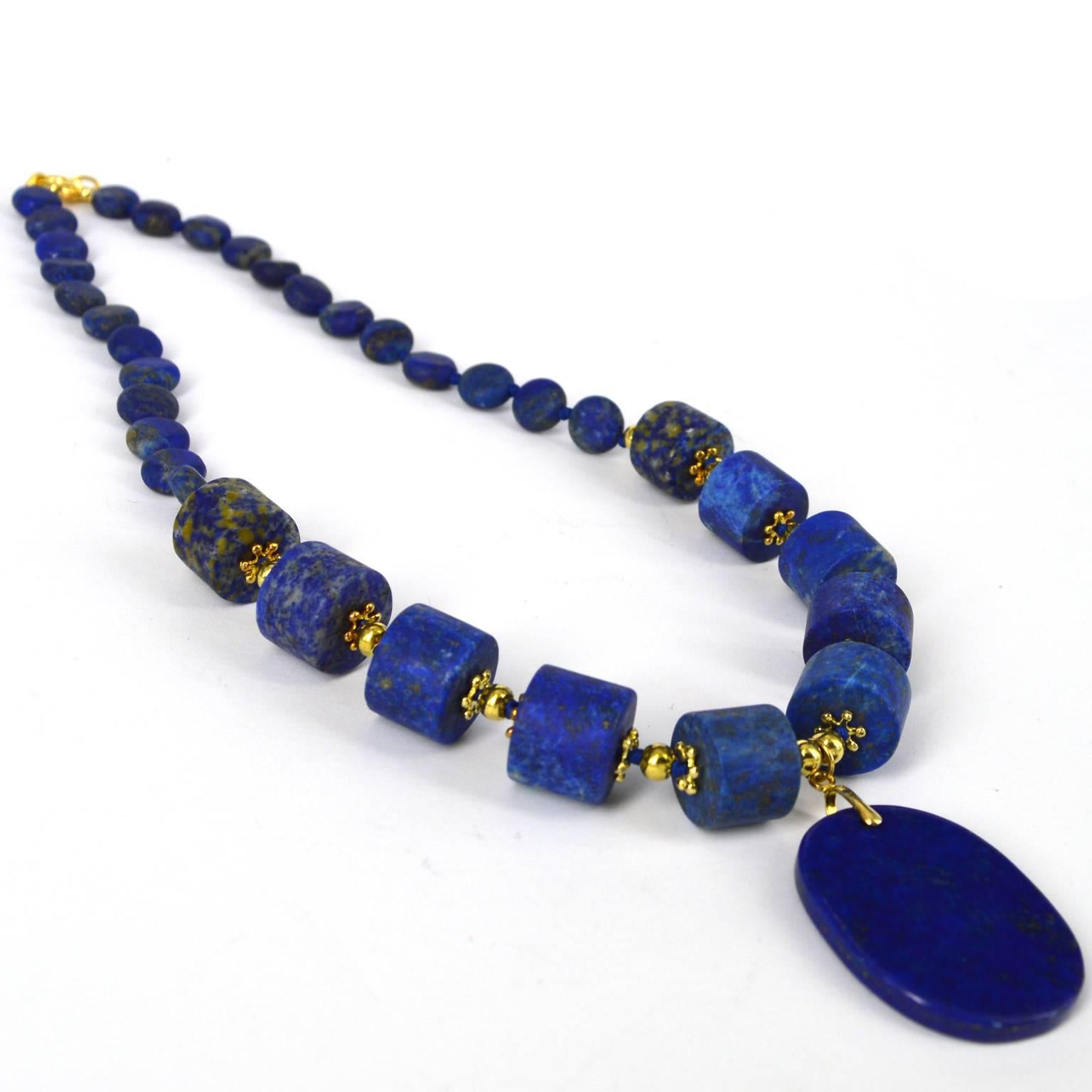 Matt Lapis Lazuli beads with Gold plate Sterling Silver spacer beads show this polished Lapis Lazuli pendant at its best. 10mm flat round matt Lapis Lazuli beads sit at the back of the necklace and the front has 10, 15x11mm matt tube beads spaced