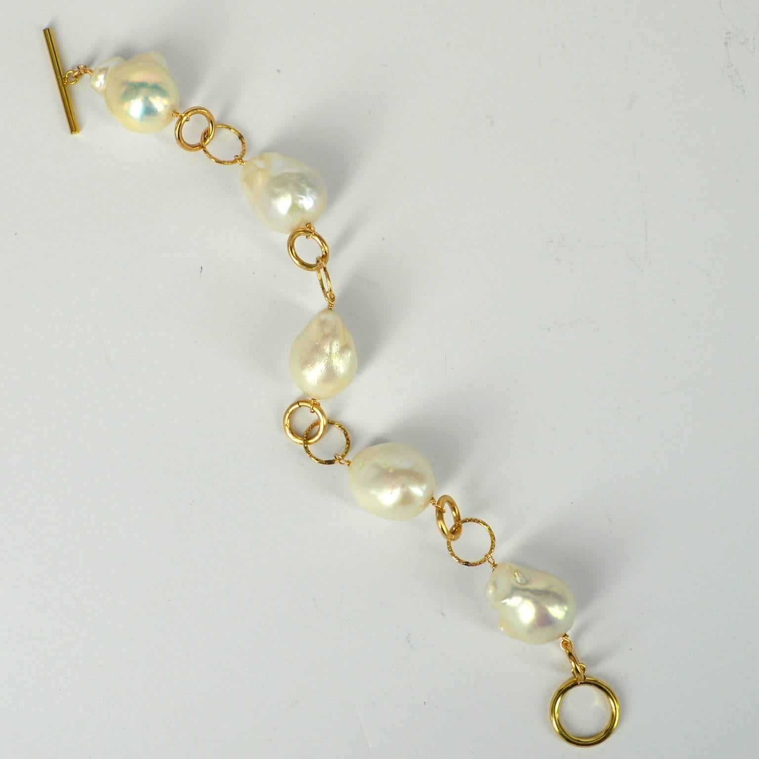 5 beautiful Baroque Fresh Water Pearls approximately 19x16mm each linked with smooth and textured 14k Gold filled 10mm rings and finished with a easy to use Toggle clasp. The ring on the Toggle clasp is 15mm and the finished bracelet measures 22cm
