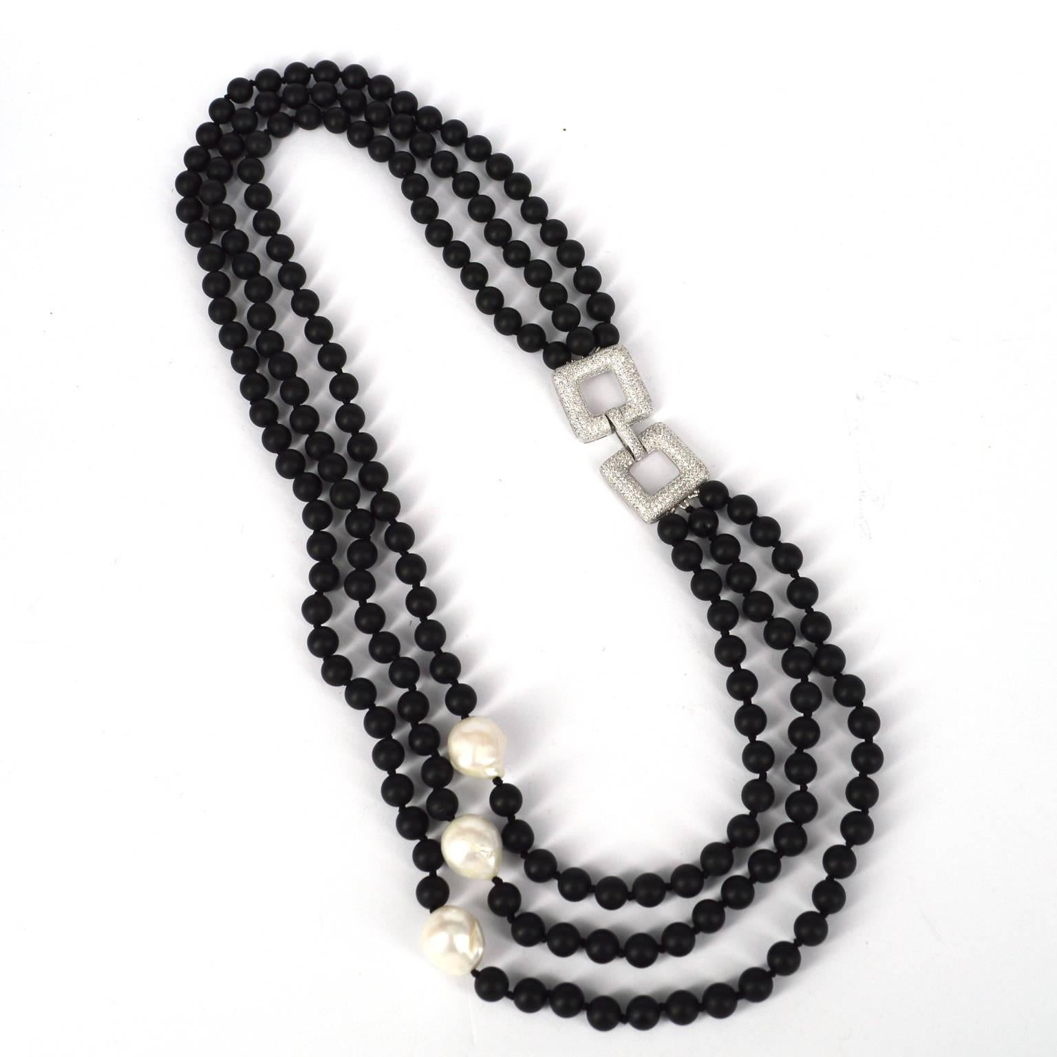3 strands of 8mm matt onyx hand knotted on black thread with 3 baroque fresh water pearls approximately 17mm each.
Stunning Rhodium plated 925 CZ geometric clasp features on the other side of the necklace.
Shorter length is 60cm Longer length is