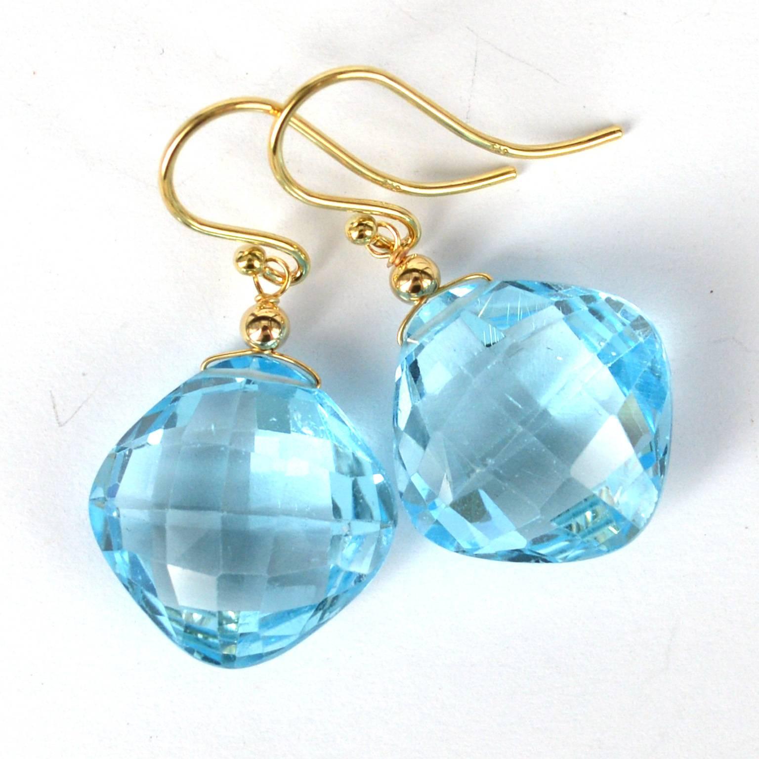 Vibrant Blue Topaz with checker board cut on the front and back sides, stones measure 16mm across when measured as a square. 14k Gold ear wires, beads and wire.
Total length of earrings is 35mm
