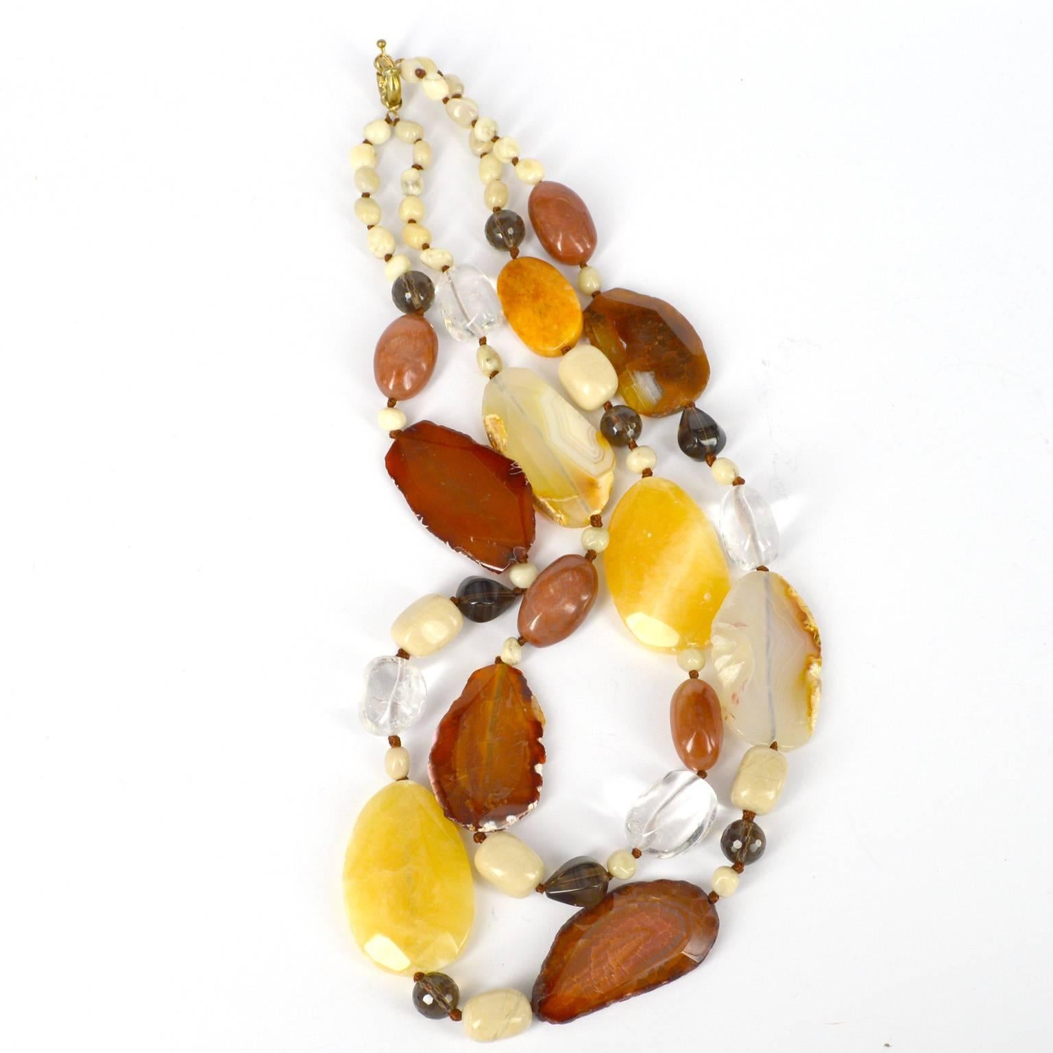 Vibrant autumn golds, reds, yellows and browns combine in this statement necklace. Large yellow beads are Butter Jade 50x33mm, and the other large beads are Agate, Clear Quartz nuggets and various shaped Smokey Quartz beads, cream beads are Ivory